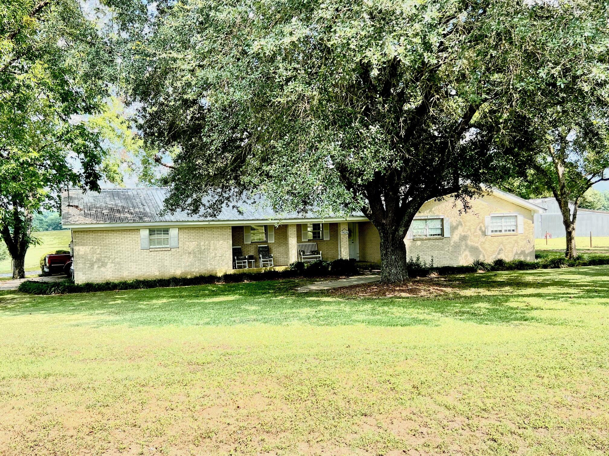 Beautiful country setting w/ 2 ponds, yet just 10 min. to Andalusia or Opp. Got it all, home, barns, guest home,  office.  Ideal for country venue, airbnb, AL dude ranch or equine facility or  family  wanting the peaceful   country life running a cattle and/or horse business.  Updated brick home,   two story barn with 1200 sf. guest house, 1 bdrm/1bath upstairs; downstairs is 1200 sf tongue n grooved interior for tool rm, tack rm  and open area, custom blt freestanding office.  Working pens for cattle, 200 ft. riding arena and 5000 sf covered barn, 9 horse stalls, equipmt barn.  New pasture fencing, underground water lines to pastures.  Ideal for cattle/ horses or growing hay. Ponds are great for fishing and picnicing.  Come home to peace and tranquility, entertainment right here at Home!