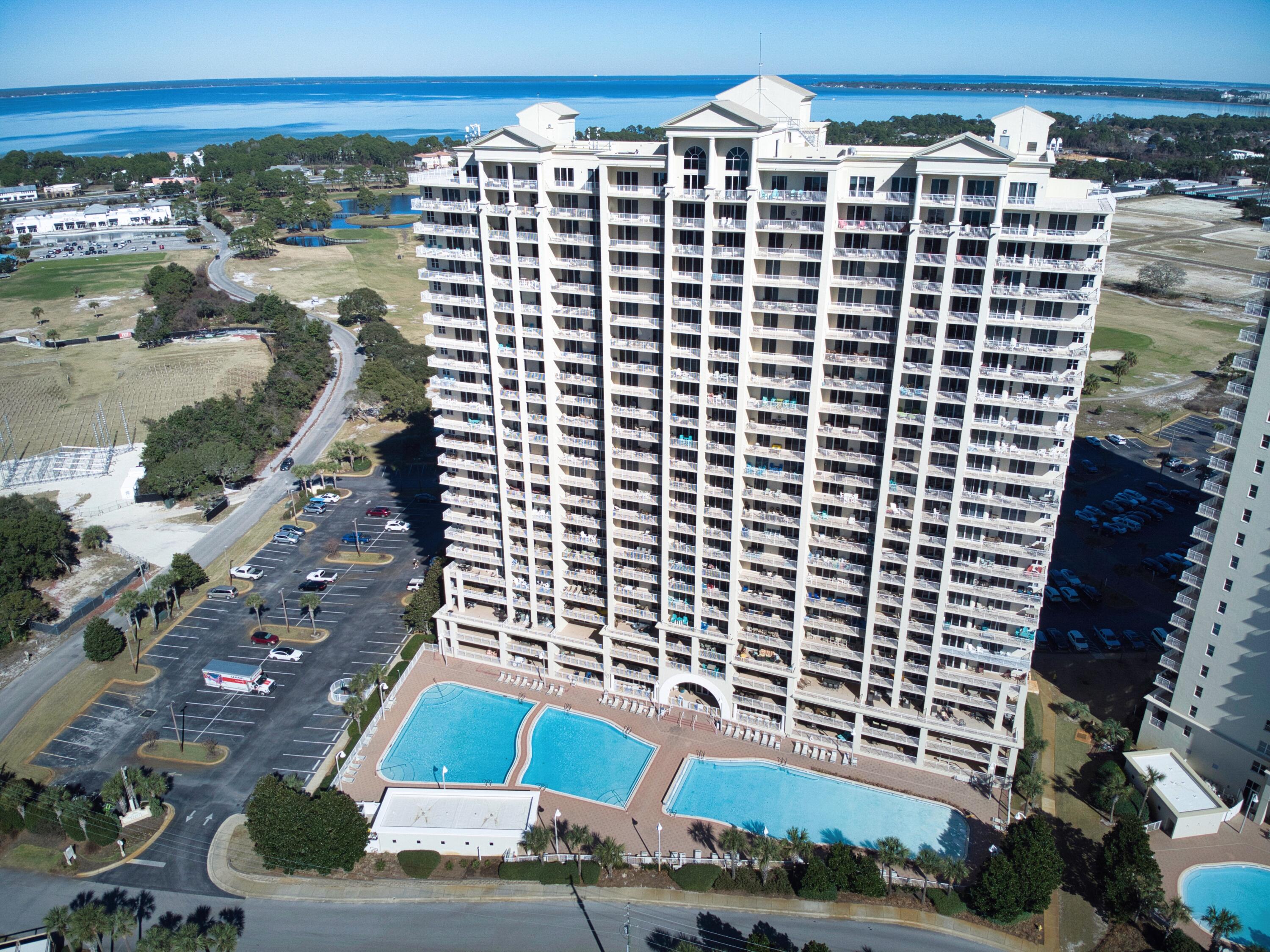 Welcome to Paradise. This 3-bedroom, 3-bathroom condo is designed with relaxation in mind. The moment you step inside, you'll be welcomed by a light-filled living area overlooking the resort style pool. The open floor plan effortlessly combines the living, dining, and kitchen spaces, creating an inviting atmosphere for gatherings. Floor-to-ceiling sliding glass doors allow for plenty of sunshine, and lead to a large, private COVERED balcony--perfect for morning coffee or evening cocktails with pool views. The primary bedroom suite, just off the living room, features a luxurious en-suite bathroom with soaking tub and separate shower. Each guest bedroom also includes its own en-suite bathroom, providing maximum comfort and privacy, with one guest room offering access to a second private balcony. Seascape is a gated 330-acre beachfront community with access to 2000 ft of white sandy beach here along the Emerald Coast. Don't miss out on this slice of paradise. Call and schedule your private tour today! 