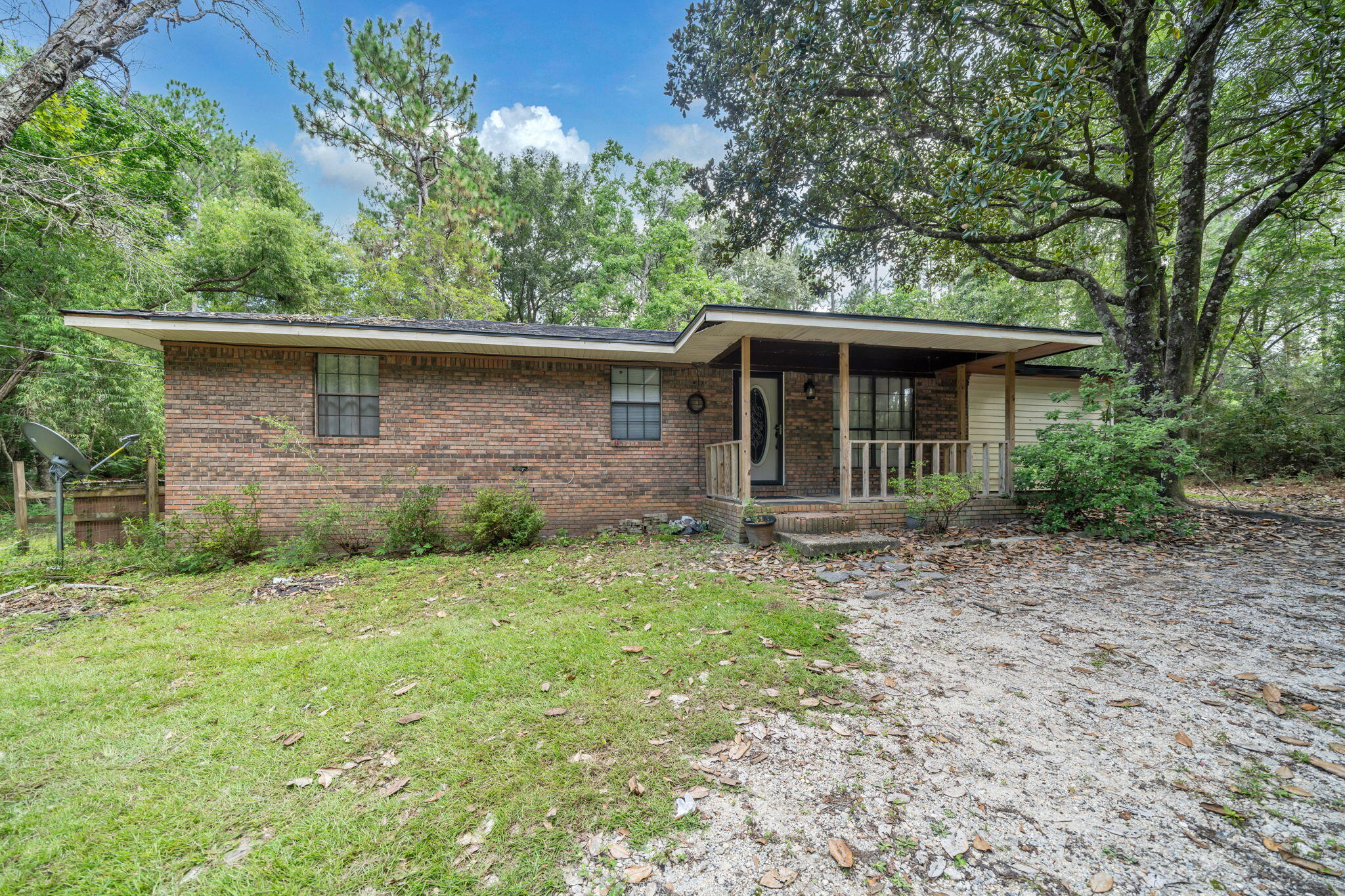 Gorgeous property with two ponds and 1.97 Acres with a stocked pond with Bass, Bluegill Brim, and shell crackers in Crestview, FL. This 5 bedroom and 1 bath home sits far back from the road down a nice long driveway. There are two ponds. The upper pond in spring fed and the lower pond has fish! The lot is very private, secluded, and quiet. Forget living in a crowed zero lot line subdivision when you can live on a two acre property!! The roof was replaced and the hot water heater is approximately 2 years old. The exterior of the home has brick veneer and vinyl siding. There is a covered front porch and an open back porch! The inside is like a Colorado cabin! There is an open floor plan with the kitchen and dining room opening to the living room. The kitchen has tile flooring, stainless and black appliances to include a slide in oven an stove and a side by side refrigerator with icemaker. The dining room does have French Doors leading to an open patio. Three of the bedrooms and one bathroom was remodeled! The bedrooms have ceilings fans and carpet an stained wood trim and doors. The hall bath is extra wide and spacious and has a tiled shower surround, newer tub, faucet and fixtures. The vanity has been updated and the hardware. There are additional guest bedrooms and a spacious laundry room. The land is just gorgeous! There is a shed for tools! The lot is cleared and also has beautiful vegetation! There is a covered pole barn or carport. The home owner replaced some interior and exterior doors, painted, and updated the home! Buyer to verify all dimensions and information!