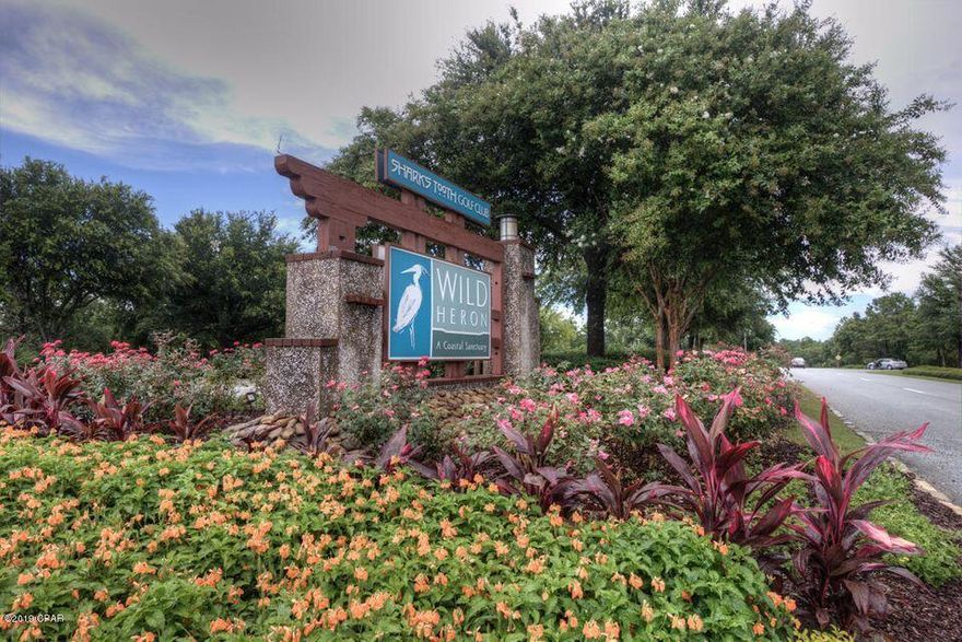 Reduction on a Large Lake and Fairway view lot with the  Potential of having a Boat Slip at the neighborhood Marina.  . Wild Heron, a 734 acre coastal sanctuary, is a gated community, on the shores of Lake Powell,one of the largest Dune Lakes in America.Wild Heron is the home of Greg Norman's Shark's Tooth Golf course.This premier neighborhood amenities include  a workout facility, heated pool with hot tub, fire pit, dock on Lake Powell, playground, kayaks, boathouse with a covered pavilion , an event lawn, and miles of hiking trails.Close enough to all Beautiful Beaches, dining, and shopping but far enough away form the noise.*Golf and tennis require an extra membership. Topo and Tree survey in documents. If important.