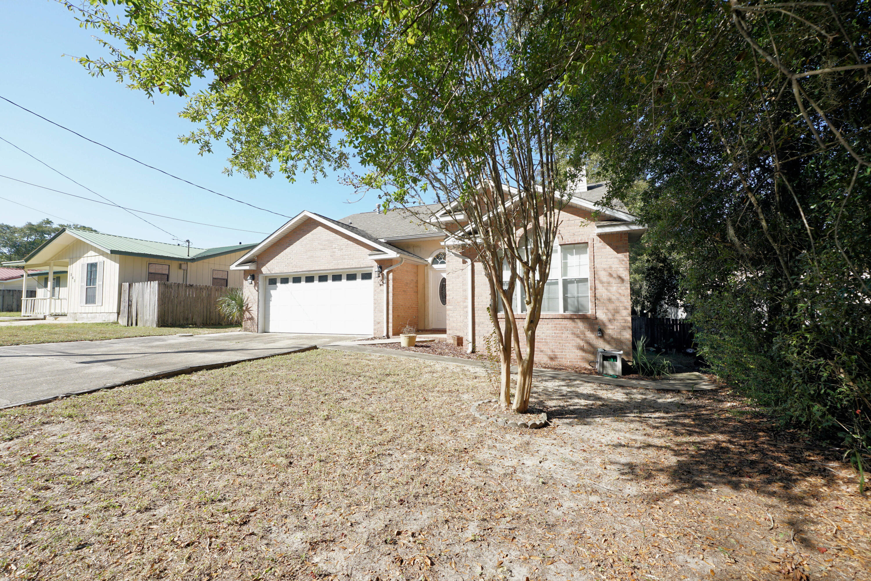 Great home in Niceville looking for new owners! This  three bedroom, two bath split floor plan home with a workshop sits on a dead end street with easy access to Eglin AFB, Northwest Florida State College, local schools, and shopping. Inside there is a large living room and spacious kitchen .The kitchen has stainless steel appliances, ample cabinets, and a pantry. The living room is large and has a gas fireplace, vaulted ceilings and laminate floors plus French doors leading to the deck. The primary suite overlooks the backyard and is a good size with an attached bathroom and walk in closet. Primary bathroom has a dual vanity, a shower and a separate soaker tub. Outside is a fenced back yard with a small deck, workshop that has electrical power and a portable AC.