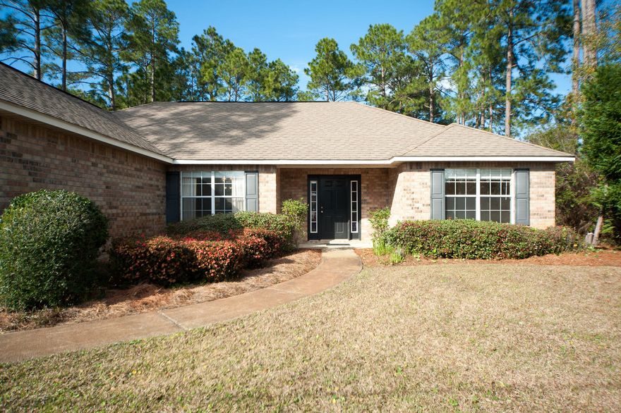 This single story brick ranch home with 3 bedrooms/2 baths is located in the heart of Santa Rosa Beach on -1/2 acre of land. The open living, dining, kitchen areas have vaulted ceilings and 18'' tile on diagonal. The master bathroom has his and her closets, double vanities, separate shower and garden tub. Home is wired for surround sound and security. Large backyard has a 20x20 concrete patio and room for a pool. The driveway offers plenty of parking and an attached 2 car garage. No association fees in this neighborhood which provides deeded access to Lake Alicia for fishing or kayaking. Conveniently located close to restaurants and shops, Sacred Heart Hospital, and just a short drive to the beaches of South Walton. Flood Zone X means no flood insurance required for lending.