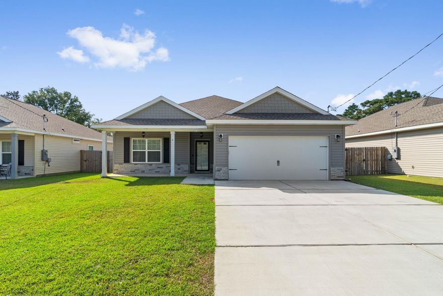 Built in 2019! Large lot with many upgrades. The stunning exterior features architecturally distinct gables with hardie shakes and a classic front porch. The interior is equally impressive and has beautiful finishing touches including upgraded Smart Core vinyl plank flooring throughout (no carpet). Ten foot ceilings in living room and nine foot ceilings throughout with tray in the master. The open kitchen has custom white shaker cabinets with soft close doors and drawers, granite counter-tops in kitchen and bath, Samsung stainless steel appliances including refrigerator. The spacious dining room leads to the covered back porch. Additional upgrades  include sprinkler system, privacy fence with gates on both sides, ring doorbell, epoxy garage flooring, and fabric hurricane shutters.