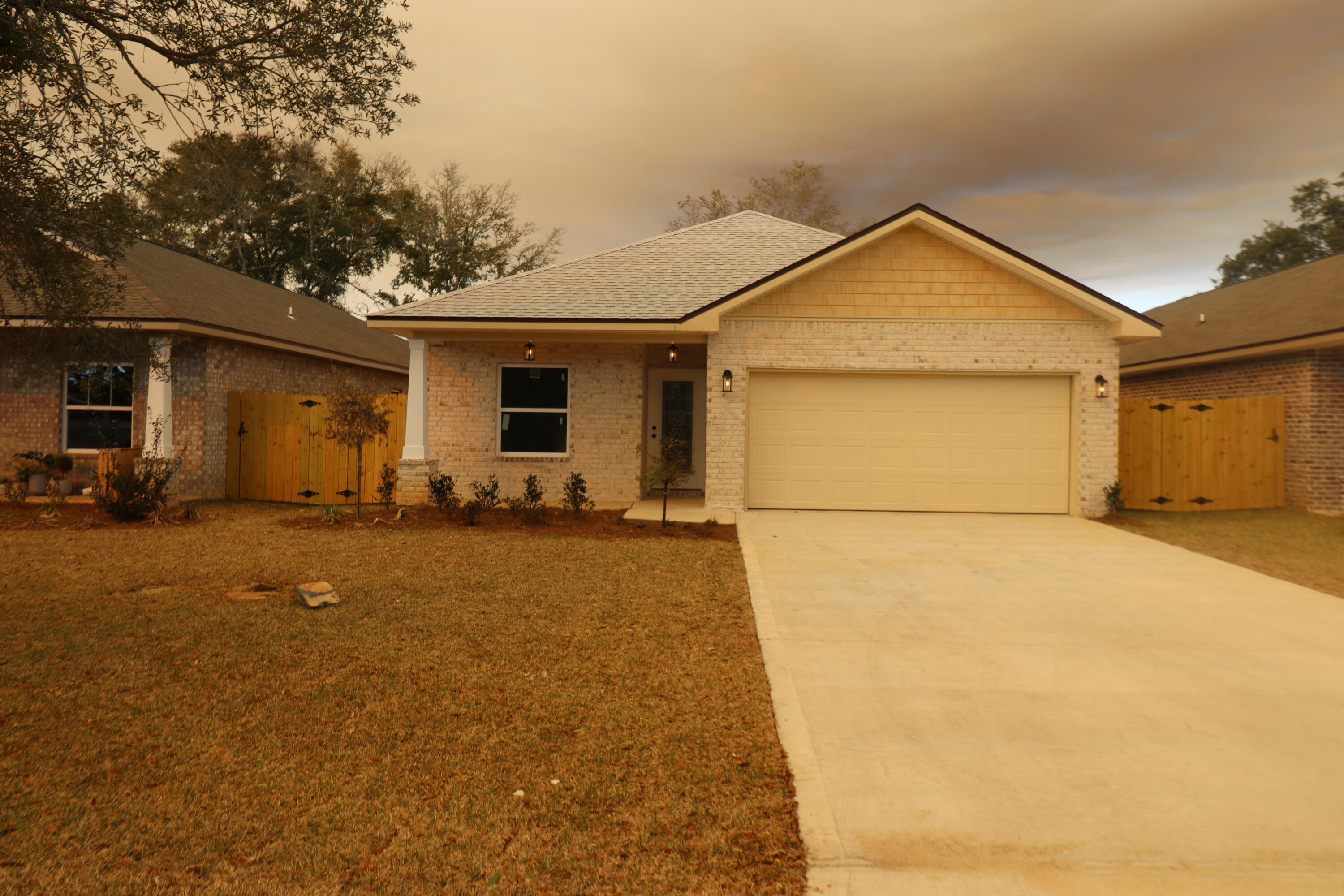 This 4/3 custom brick home has super curb appeal. There are 10 Ft. Ceilings w/ impressive crown molding, has LVP flooring throughout most of the home except for the wet areas which are tiled. The gourmet kitchen boasts white cabinetry, granite countertops, a breakfast bar and stainless appliances including a full size refrigerator and freezer. Bedrooms 1 and 2 are located near the front entry along with bathrooms 1 and 2. The master suite is located at the rear of the home and has a double vanity, 2  walk -in closets, and a combo tub and shower with a glass enclosure. The oversized great room is located at the front of the kitchen and opens to a covered patio. Yard is fully sodded/ landscaped and fenced and comes complete with a well and sprinkler system. Completion expected in mid March.