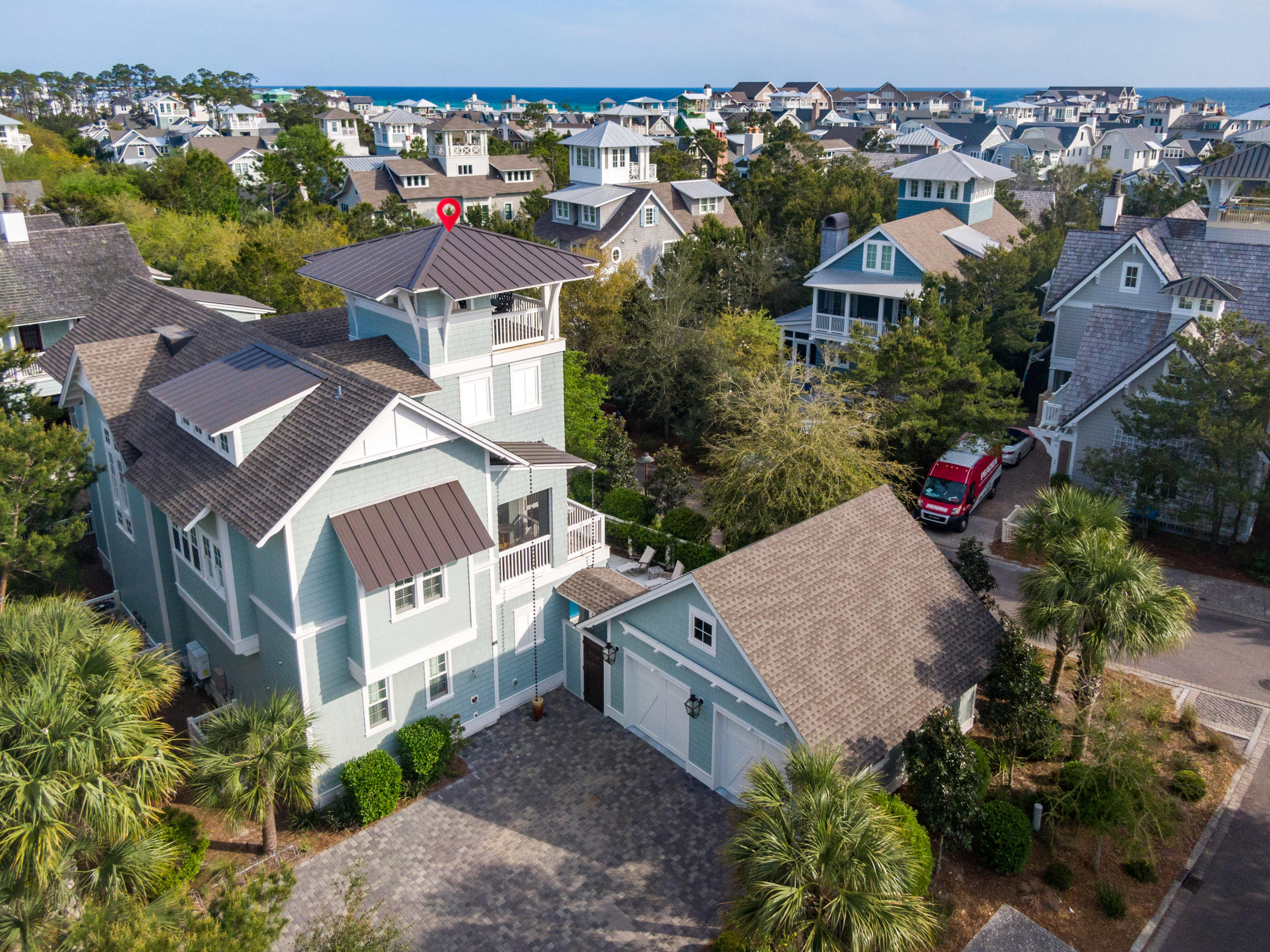 Enjoy a welcoming coastal ambiance at this charming WaterSound Beach residence featuring detailed craftsmanship, custom design throughout & gorgeous outdoor spaces including a private pool. Notice meticulous attention to detail from the moment you enter with rich-toned wood floors & beautiful millwork including stacked crown molding & designer coastal-style lighting fixtures. The first level includes the open concept living & dining areas with white shiplap ceilings & exposed wood beams. At the heart of the spacious living area find a cozy marble fireplace & ample room to gather while the dining area features a stunning oyster shell lighting fixture. The fully equipped kitchen offers custom white cabinetry, marble counters, a large center island ,icemaker, two dishwashers, double oven,