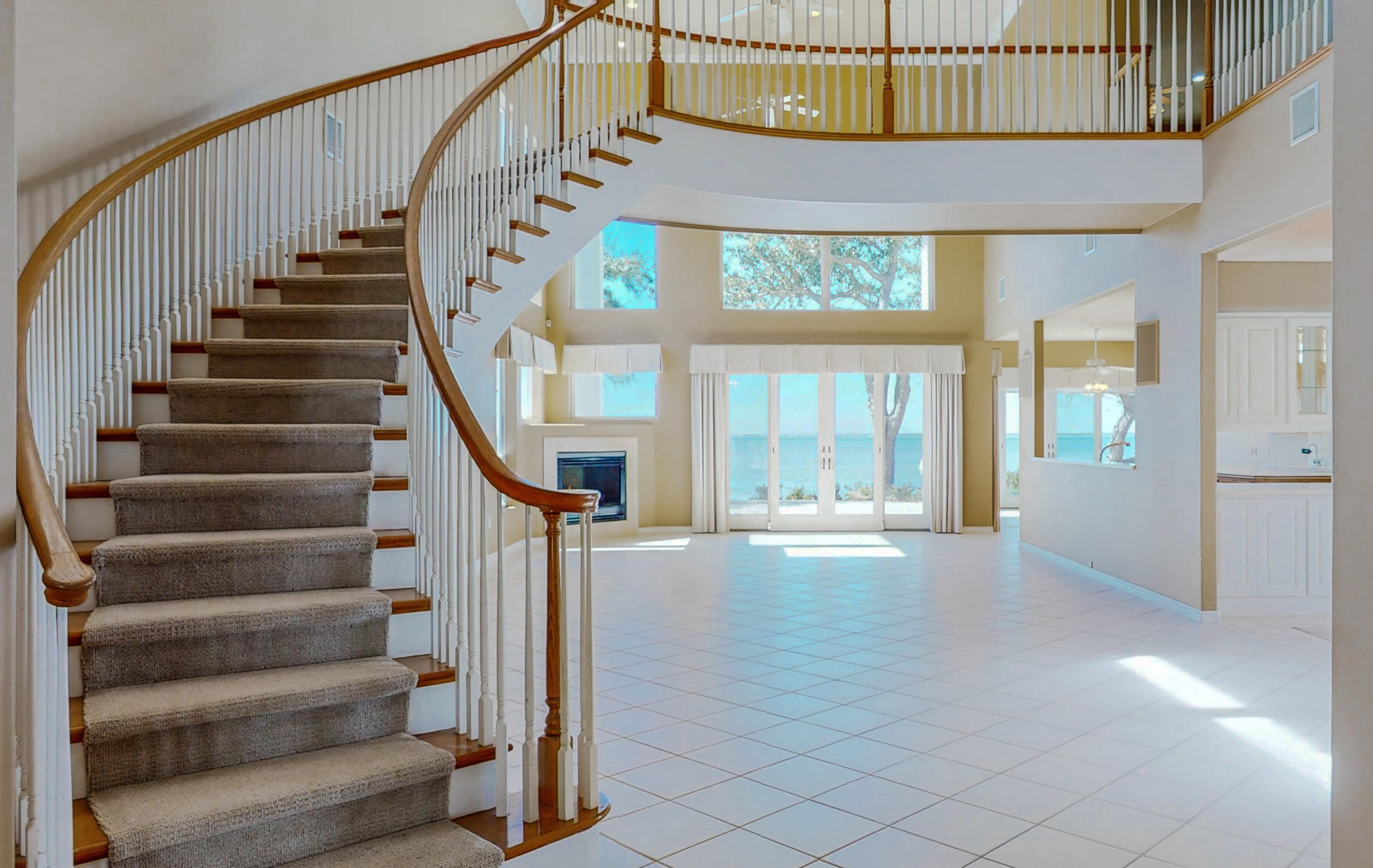 Contemporary Bay Front Home in Burnt Pine - A dramatic entry opens to a winding staircase and two story Anderson picture windows and sliders which invite magnificent Bay views to dominate the home.  Spacious kitchen is flanked by intimate dining room and sunny, bay facing breakfast room. The perfect flow for entertaining!  Two large 1st floor bedrooms, including Bay fronting Master Bedroom.  Two additional second floor bedrooms, each with ensuite bathrooms.  New dock and seawall was installed in late 2021, with 8,000 boat lift.  Lawn maintenance and irrigation are provided by the Bay Villas HOA.  Don't miss this one, it will go fast!