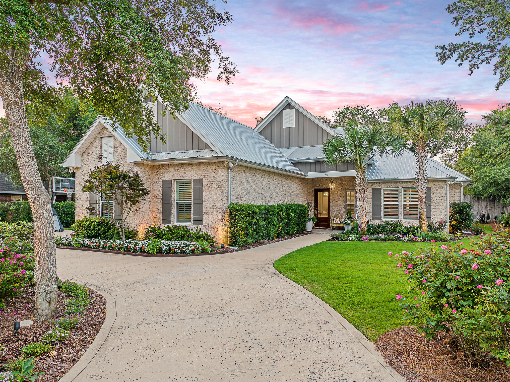 Waterfront living without the waterfront price tag. Bayou Point offers a unique opportunity to have your own boat slip within the confines of the community dock. This custom home was built by Cogent Builders and provides a very desirable floorplan. Upon arrival, you are welcomed with mature landscaping as well as a circular drive with extensive parking. The combination of brick and hardi-board exterior with metal roof makes for both a classic clean look as well as providing durability and easy maintenance. You are greeted at the front door with an oversized mahogany wood door and tiled front porch. As you step inside, you'll immediately notice the attention to detail and modern amenities that make this home stand out. The interior is designed for comfort and functionality, with stunning tile flooring throughout, providing both durability and a warm aesthetic. The heart of the home, the kitchen, features an oversized island that invites you to gather around and create lasting memories. With top-of-the-line Thermador appliances, a gas range, wine cooler, and a convenient farmhouse sink, cooking and entertaining become a delightful experience. One of the highlights of this home is the state-of-the-art central vacuum system that makes for easy cleaning. The first floor layout boasts a generous master suite with double walk-in closets, open concept living/dining/kitchen, 2 additional bedrooms with Jack and Jill connecting bath, powder room, mud room entry from garage, laundry room and a screened back porch. There's a whole house water filtration system in addition to the filtration system connected to irrigation. The downstairs also features a Sonos surround system. Upstairs features an additional bedroom and bath plus a landing area. All windows and doors are impact glass providing security during any potential inclement weather. Stepping into the garage, and you'll find an epoxy floor that adds a touch of sophistication and makes maintenance a breeze. The garage offers ample storage space, allowing you to keep your belongings organized and easily accessible. Outside you will find a nice lawn with ample room to add a pool if someone desired. Bayou Point is conveniently located close the beaches of South Walton along 30A, shopping at Grand Boulevard, Sacred Heart Hospital, and Topsail Hill Preserve State Park.