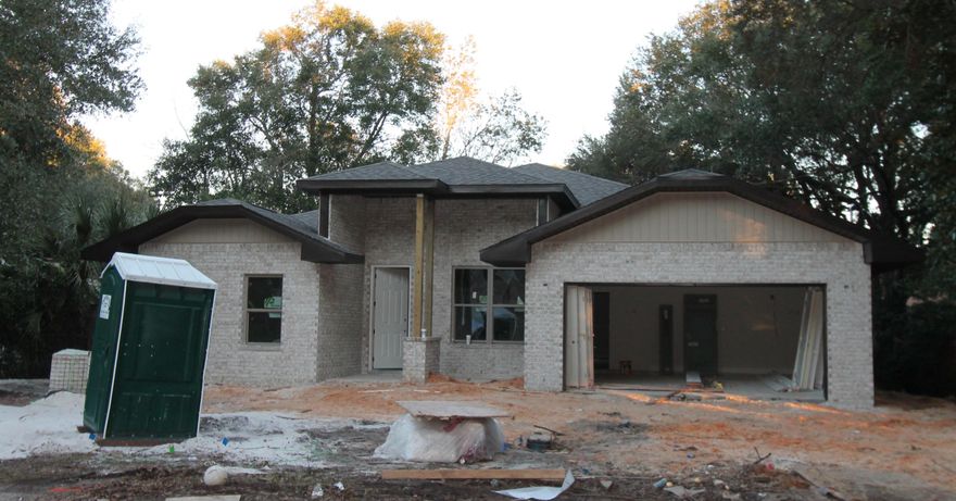 Awesome floor plan offered by 2018 Parade of Homes winning builder! This 4/3 custom brick home has super curb appeal, and is being constructed on a lot in a quiet Shalimar neighborhood. There are 10 Ft. ceilings w/ impressive crown molding, plank tile flooring throughout the main living and wet areas, and 5 1/4'' baseboard throughout. 8 Ft. doors are throughout most of the interior of the home. As you enter the home through the covered front porch, the formal dining room is on your right. As you continue down the hallway, you will then enter the chef's delight kitchen which boasts custom painted Ivory cabinetry, granite countertops, 2 large pantry's, and stainless appliances (including an oversized commercial grade refrigerator/ freezer).