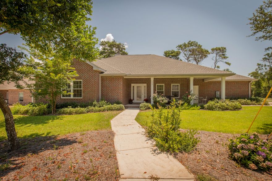 This is an absolutely beautiful home located on a very generously sized lot in the heart of Destin. The curb appeal and large covered porch welcomes you to this all brick contemporary house. Inside you will find hardwood flooring, tall ceilings, a beautiful kitchen, large bedrooms, and is finished nicely with tall base boards, crown moulding, and painted throughout. The back yard is large and very private. Priced to sell. Come by and see it for yourself!