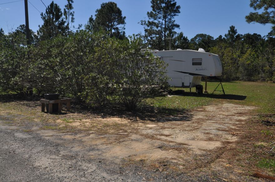 Great dry clear lot with sewer, water, electric, storage shed with washer and dryer, and a nice camper on site. In a quiet nieghbor hood at the end of a cul de sac.