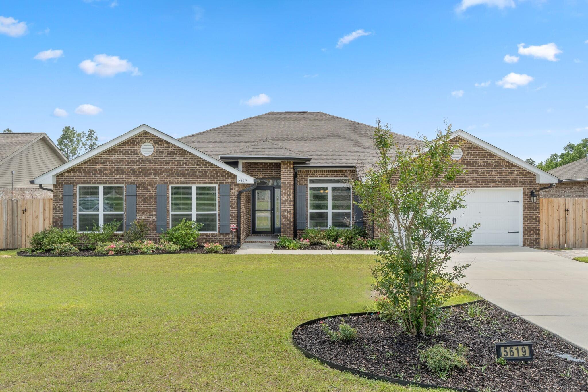 Welcome to your Milton dream home! This BEAUTIFUL, newer construction, 4 bedroom, 3 full bathroom home in the Hamilton Crossing neighborhood is move-in-ready and features tons of seller updates and thoughtful touches throughout - Starting with the front landscaping for excellent curb appeal. One of the standout features of this home is the propane powered full-house Generac generator, ensuring you're never without power - an excellent perk for Florida living. Inside, you'll find an open concept floor plan with modern finishes, spacious living area, dining room, separate breakfast nook, and a well-appointed kitchen for entertaining. The generous sized chef's kitchen offers plenty of counter and cabinet space, stainless steel appliances, and a large walk-in pantry right as you walk in the laundry room. The GORGEOUS custom deck and terraced backyard sets the perfect scene for a fantastic outdoor entertaining space with a fully fenced in backyard, as well as a screened in patio. The primary suite features a spa-like ensuite with garden tub and updated walk-in shower, 2 walk-in closets, water closet, and a double vanity. Down the hall you'll find the additional 3 bedrooms and 2 full bathrooms, as well as hall closets for additional storage space. Schedule your showing today, and come see this solid smart home!