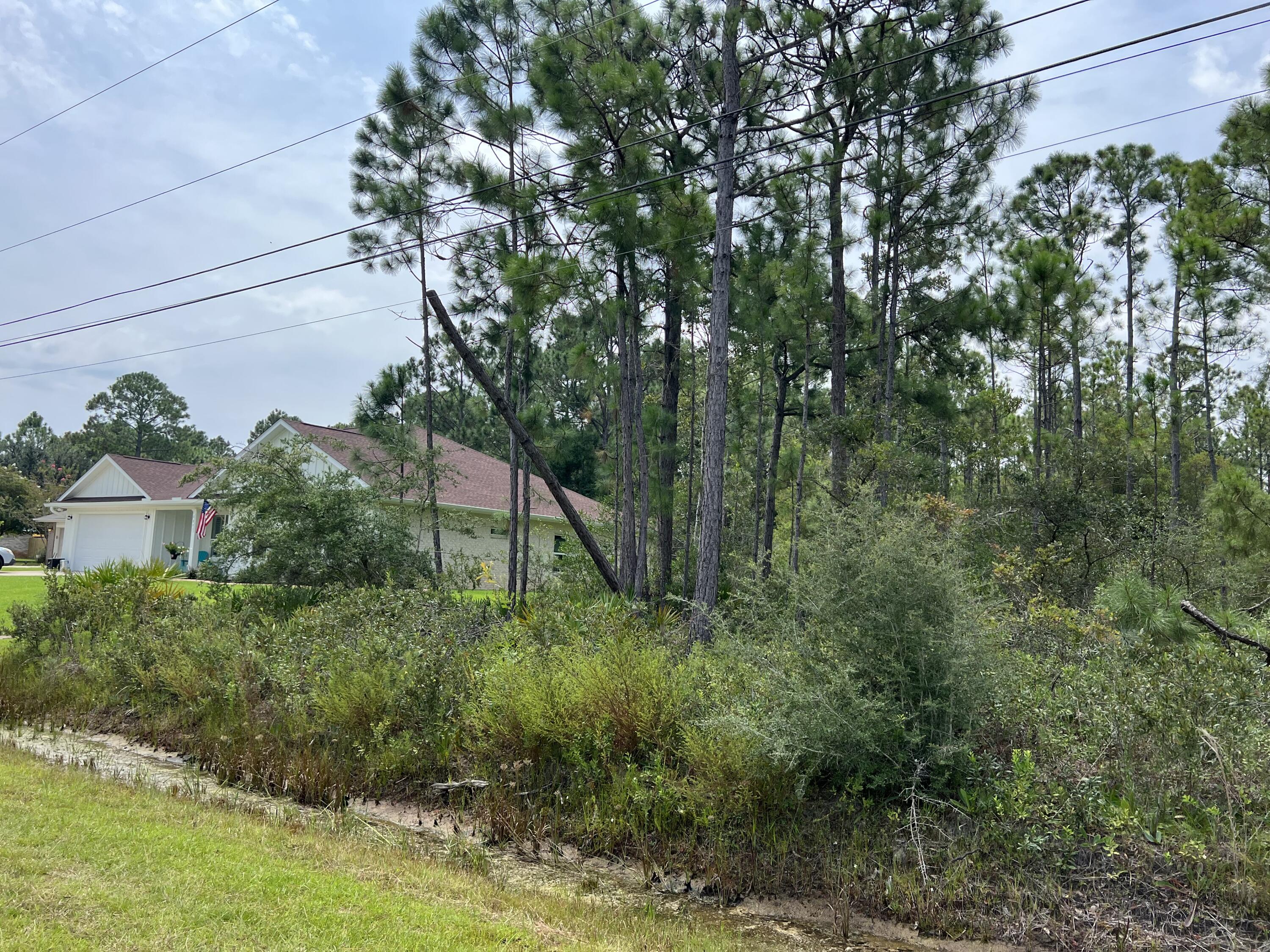 Come build your dream home on the last lot that can be built on before the green belt; This will give privacy to the West of the house that is built; Imagine knowing no one can build to the West of your lot! Enjoy the amenities of Holley by the Sea: 3 Pools, Tennis courts, Gym, Sauna, and many more!