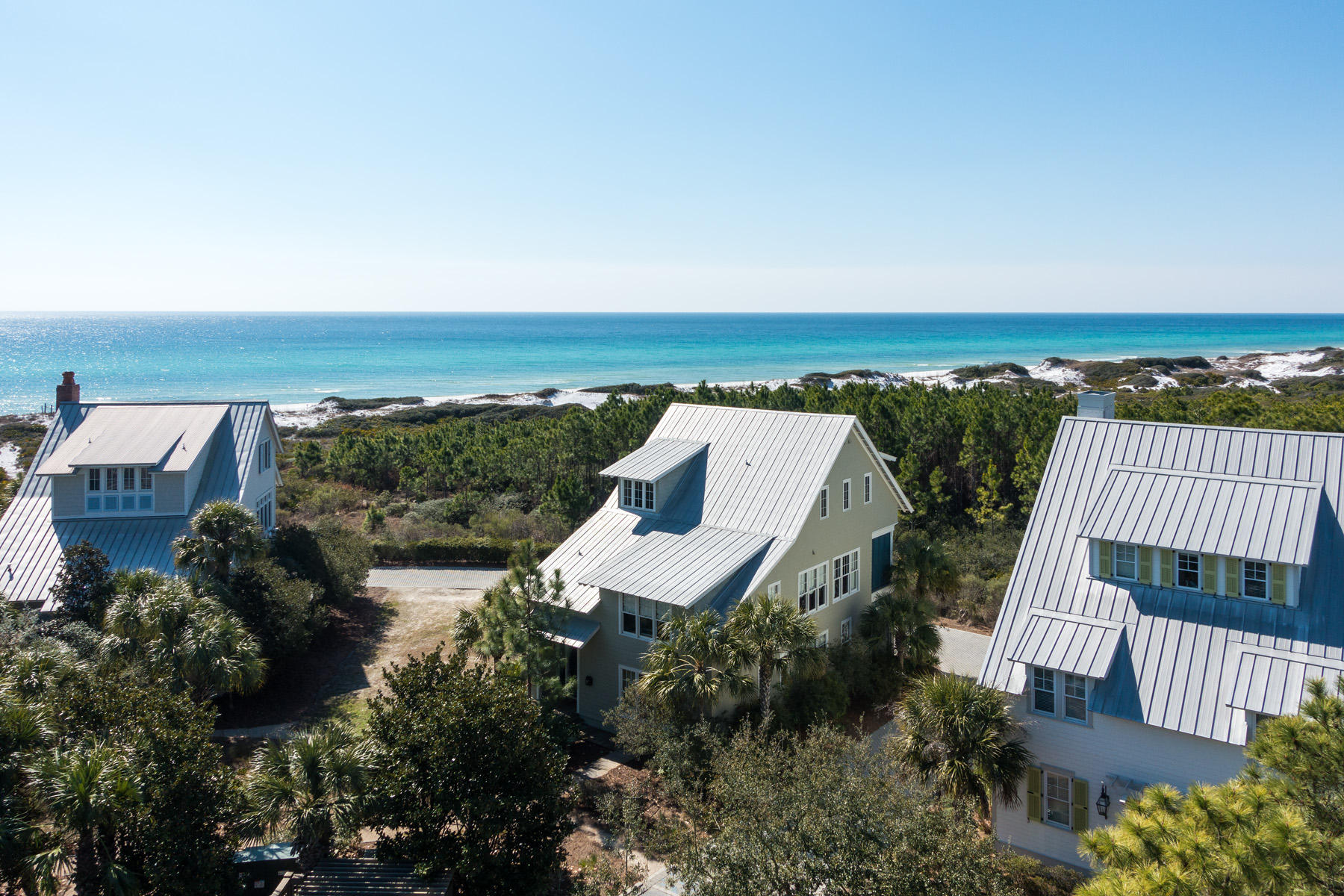 One of the finest homes in the Watercolor Community, 105 Park Row Lane is located in the highly sought after Gulf District. It overlooks the rare beauty of the area coastal dunes as well as the Gulf of Mexico. It takes less than a minute to walk to the renowned WaterColor BeachClub and access the turquoise waters and white sand beaches. The back of this professionally decorated home borders Grayton State Park, making the covered deck that runs the length of the house private. Design features include: black walnut custom cabinetry and floors, built in whole house stereo system, custom closet systems, mahogany framed windows and doors and an alarm system.