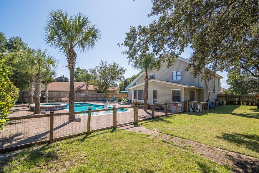 This stunning pool home is renovated and move-in ready! Tile and new Aduramax luxury vinyl plank flooring throughout second floor. Beautiful kitchen featuring a fireclay farmhouse sink and rococo quartz counter tops. Abundant cabinet space and a pantry for all the storage you are looking for. The living room is open to the dining room flooded with natural light. Relax in the den just off the kitchen complete with gas fireplace and french doors leading out to the pool. The low maintenance, salt water gunite pool has a waterfall feature and plenty of entertaining space on the pavered patio. Make sure to check out the Matterport 3D virtual tour to truly appreciate all the upgrades in this home.