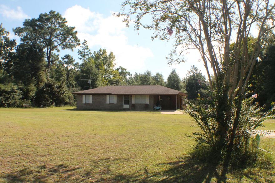 All brick on over one level acre. Paved road near town! Come home to Sundew Street today! This well kept all brick slab on grade home is ready for the family ! Three bedroom one and 1/2 bath with a covered carport and a parking /basketball slab! laminate wood style flooring, ceiling fans, open eat in kitchen with a window sink overlooking the back yard! Quick commute to Eglin, Duke Field ,Army 7th bases and the whitest beaches in the world! The Beautiful Emerald Coast at your fingertips. The yard is mostly cleared level and ready for a football game or a barn!