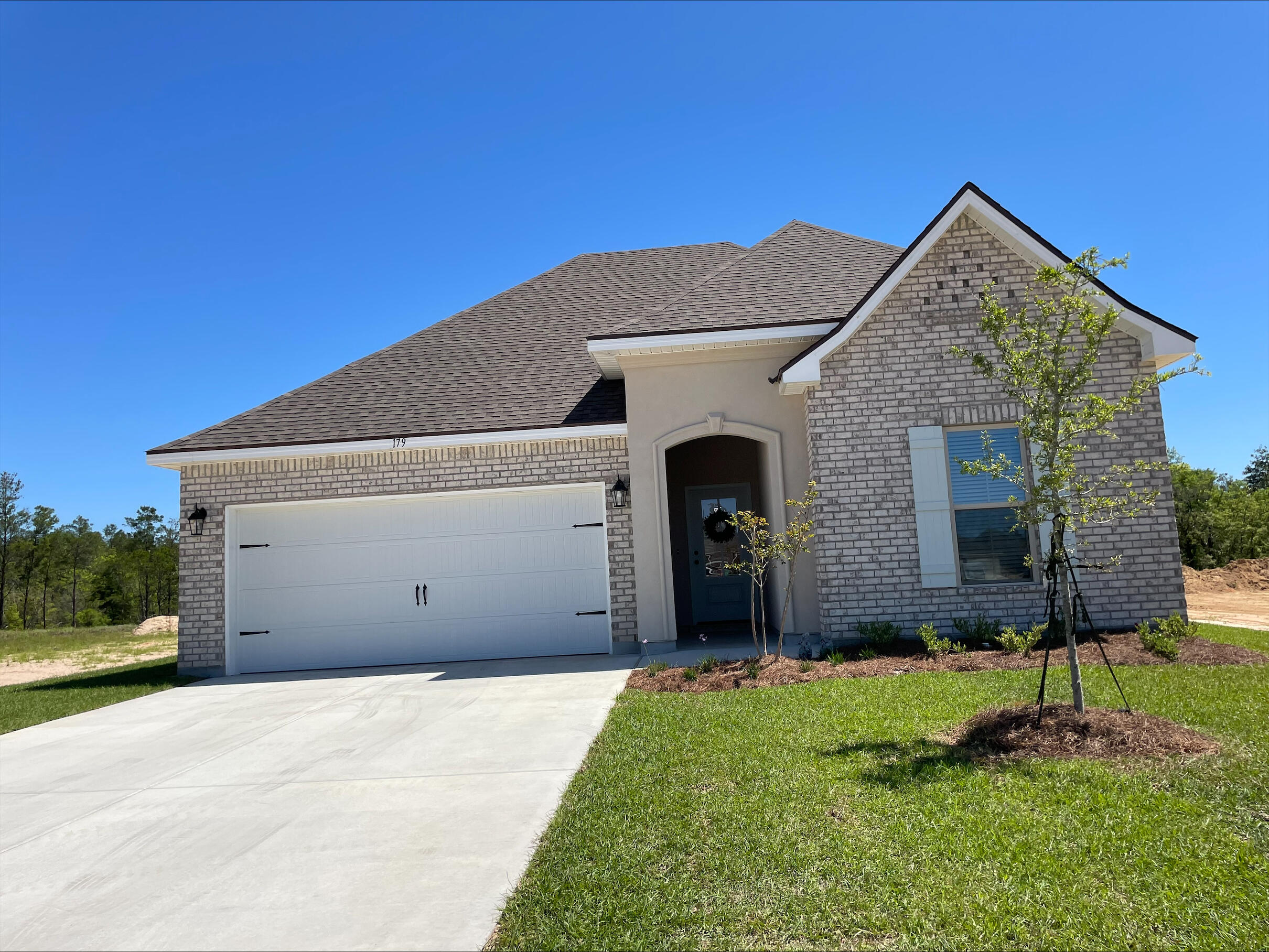 The TRILLIUM IV A in The Bluffs at Lafayette community offers a 3 bedroom, 2 full bathroom open and split design. Upgrades added (list attached).Special Features: double vanity, garden tub, separate shower, and walk-in closet in master suite, master closet continues through to laundry room for added convenience, kitchen island and walk-in pantry, covered rear patio, recessed lights, crown molding, framed mirrors in bathrooms, undermount sinks, landscaping, architectural 30-year shingles, flood lights, and more!Energy Efficient Features: tankless gas water heater, kitchen appliance package with gas range, vinyl low E windows, and more!