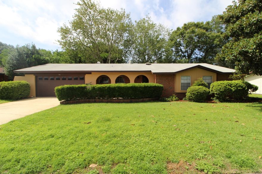 AT LAST YOUR OWN HOME! Fantastic curb appeal and inviting entry. Step into the foyer to find tile flooring and a skylight for natural lighting. Spacious living room with double sliding glass doors across the back overlooking the beautiful deck area and arbor. Dining area opens into the living room for easy entertaining. Kitchen has lots of cabinets and counterspace, double windows, pantry and a breakfast area. Master bedroom has an extended closet. Master bath has a walk-in shower. Two additional bedrooms each with window seats. Garage has a built-in work bench and also a separate laundry room and storage area. Beautiful backyard with lots of decking and built-in benches perfect for grilling out this summer. Close to schools, shopping, restaurants, beaches, downtown Fort Walton