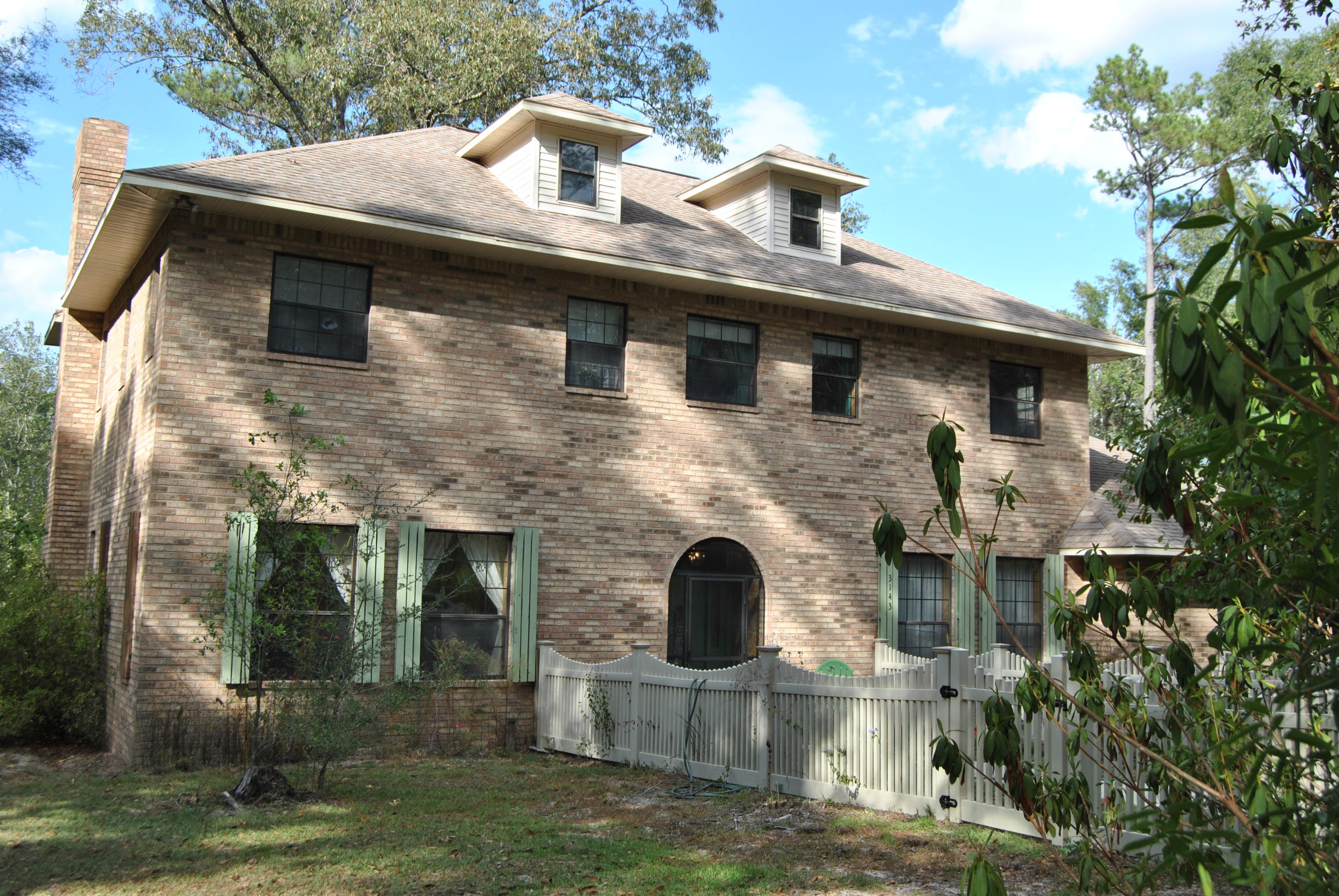 CURRENTLY UNDER CONTRACT...SELLER IS ACCEPTING BACK UP OFFERS Lovely Georgian style home situated o thirteen acres in a secluded setting located in Bonifay. Hardwoods, dogwoods, azaleas and fruit trees surround this all brick two story, five bedroom, three bath property. Other features include formal living and dining areas, extra large kitchen with birch cabinets and Corian countertops, study, brick fireplace, newly installed well and loads of privacy. Seller custom built this home to last and it has been well loved.