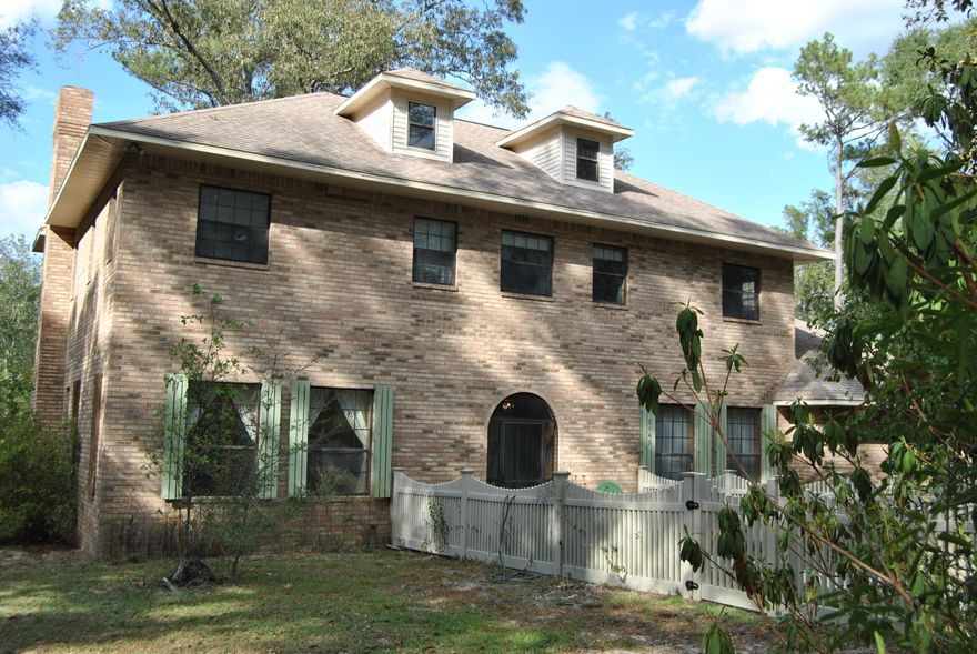 CURRENTLY UNDER CONTRACT...SELLER IS ACCEPTING BACK UP OFFERS  Lovely Georgian style home situated o thirteen acres in a secluded setting located in Bonifay. Hardwoods, dogwoods, azaleas and fruit trees surround this all brick two story, five bedroom, three bath property. Other features include formal living and dining areas, extra large kitchen with birch cabinets and Corian countertops, study, brick fireplace, newly installed well and loads of privacy. Seller custom built this home to last and it has been well loved.