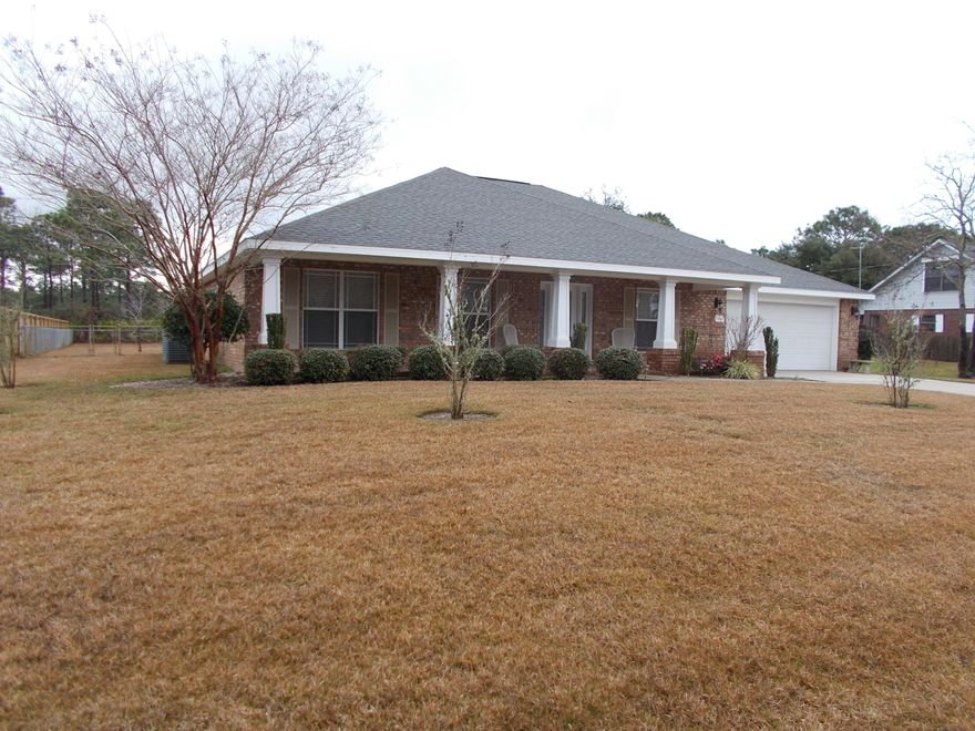 This classic brick home with craftsman style porch columns located in Holley By the Sea is available immediately for a new family. Built in 2009, this home is immaculate and has all the bells and whistles. Lovely porcelain tile floors run throughout the home (no carpet). There is a custom glass door with side light panels to welcome your guests. Inside, you'll appreciate the large rooms and split bedroom floor plan. The large kitchen offers lots of room for the family and includes lovely wood cabinets with granite counter tops, stainless steel appliances, a cooks island and gorgeous lighting both under the cabinets and with pendants.
