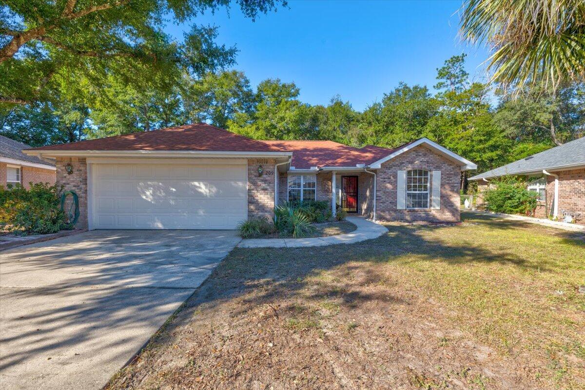 Welcome to 209 Evergreen Avenue! Centrally located in the heart of Niceville, this beautiful 3 bedroom, 2 bathroom brick home features an open floor plan with spacious master bedroom, an updated kitchen, luxury vinyl floors throughout and a gas fireplace. Granite countertops and stainless steel appliances in newly updated kitchen that opens up to breakfast nook overlooking backyard. Spacious master bedroom with walk-in closet and master en suite bathroom. Spilt floor plan with two additional bedrooms and hallway bathroom located off the living room. Dining room and living room are inviting and cozy and feature gas fireplace that overlook the over-sized screened in porch. Fenced backyard is spacious and peaceful - plenty of room for endless backyard entertainment!