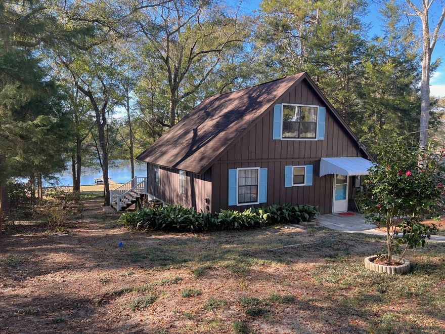 Cozy waterfront home on Juniper Lake w/ balcony, FL room, private dock. Juniper Lake has some of the best fishing in the panhandle (bass, blue gill, catfish). Fenced yard w/ circular drive, RV carport. Workshop at front, garden shed in back yard. Living Room overlooks the lake w/ sliding glass doors leading out to the FL Room. 1 BR upstairs also overlooks lake & opens onto upstairs balcony. Previous owner installed new septic tank, lift station & new drain fields in May '12. New shingle roof to be installed w/in 30 days. New HVAC '21; Water heater apx. 3 yrs; Septic last pumped late '19 or early '20; Deck boards on dock replaced apx. 3 yrs; House deck & balcony boards and railings replaced '22. Refrigerator, light fixtures, fans new '22; Stainless stove, dishwasher, microwave brand new!