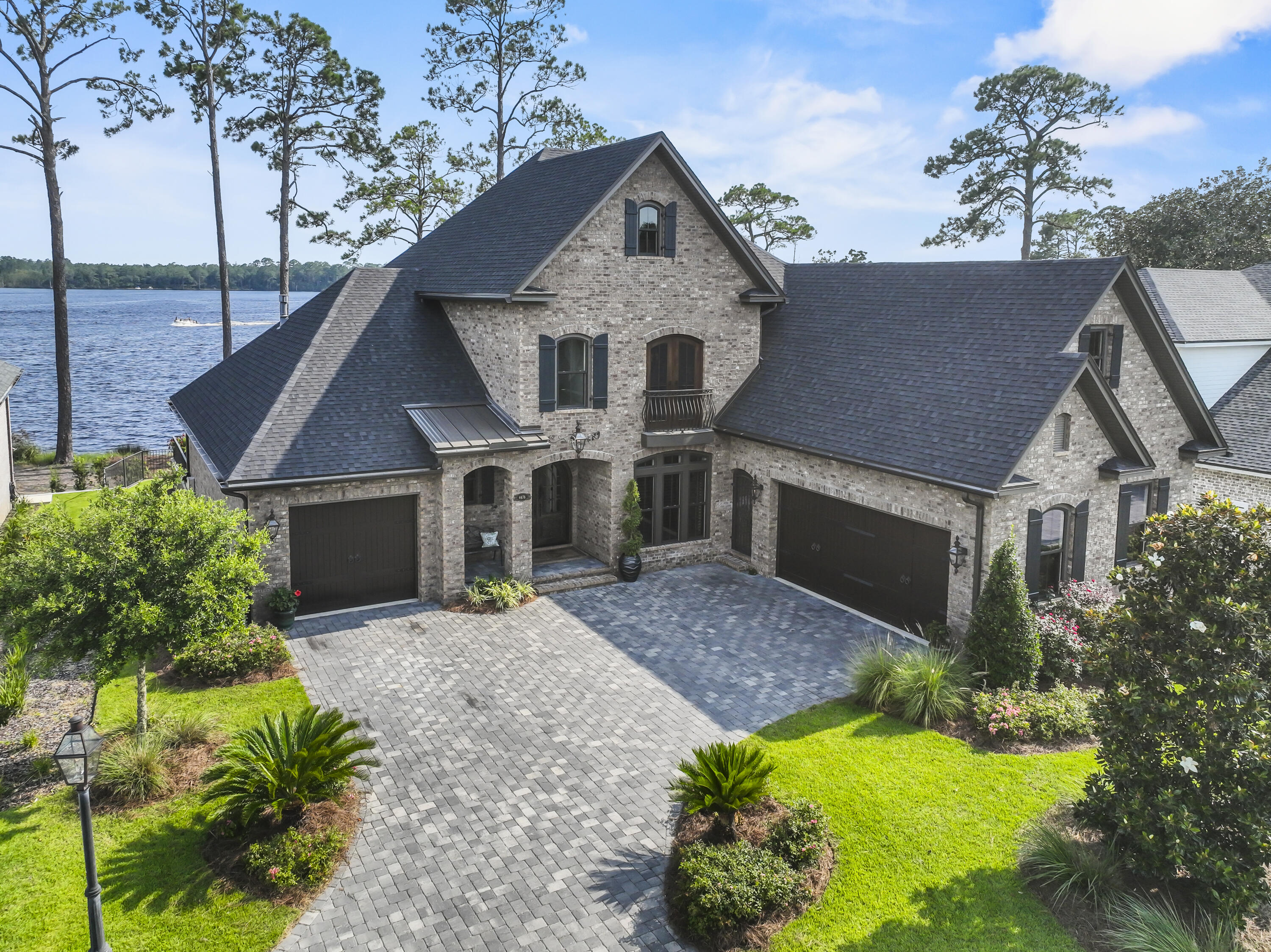 Majestic Waterfront Estate with custom impressive details and an open floor plan where relaxed living and southern hospitality flawlessly weave. Perfectly situated on Rocky Bayou's Aquatic Preserve, this home boasts a gorgeous pool with a spacious patio, pool bath, boat dock with lift, jet ski lift, pool table/rec room, gleaming hardwood flooring, and thoughtful details in every room. Covered porch offers a shady place to unwind and enjoy year-round sunsets. Lush landscaped grounds. Two extra-large two car garages allow room for your leisure vehicle. Inside, a grand foyer opens to a beautiful custom 18ft ceiling where the office has a custom floor-to-ceiling brick wall. Gorgeous water views are the star of the show and are maximized by the large windows and porch access from