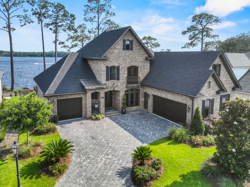 Majestic Waterfront Estate with custom impressive details and an open floor plan where relaxed living and southern hospitality flawlessly weave. Perfectly situated on Rocky Bayou's Aquatic Preserve, this home boasts a gorgeous pool with a spacious patio, pool bath, boat dock with lift, jet ski lift, pool table/rec room, gleaming hardwood flooring, and thoughtful details in every room. Covered porch offers a shady place to unwind and enjoy year-round sunsets. Lush landscaped grounds. Two extra-large two car garages  allow room for your leisure vehicle. Inside, a grand foyer opens to a beautiful custom 18ft ceiling where the office has a custom floor-to-ceiling brick wall. Gorgeous water views are the star of the show and are maximized by the large windows and porch access from