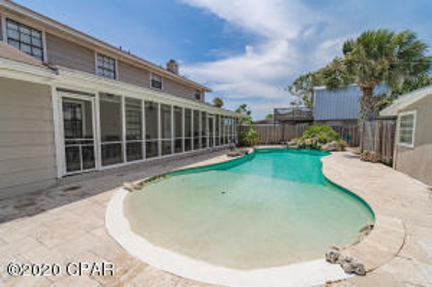 This is a spectacular opportunity on the west end of Panama City Beach to own 3 properties all grouped together !!!  This multi family complex is only 1 block to the sand and will make an incredible short term rental compound, perfect for family reunions. The main home is over 4000 sq ft with two living quarters, one side is a self contained one bedroom suite with separate entrance and the other side is 4 bd 4.5 bath and large loft bonus room.  The adjacent home faces Derondo st. It is  a sweet 2 bed Florida cottage with a large fenced in the backyard.  The 3rd property has 1000 sq ft space (used as storage now) and  oversized 2 car garage, carport and extra large driveway. There is a gorgeous custom resort style pool nestled between the properties. The entire complex sleeps between 18-24