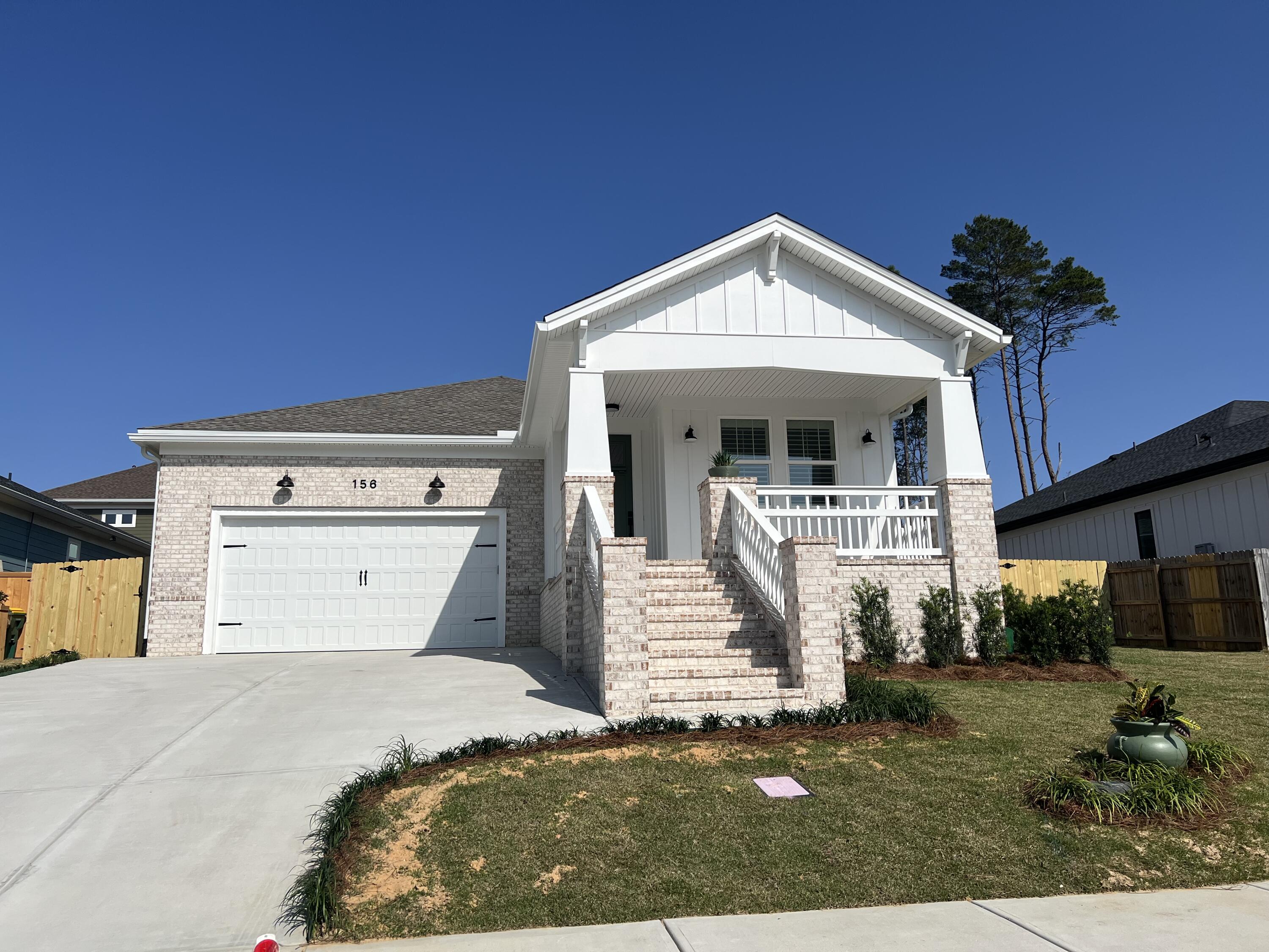 NEW home in Deer Moss Creek! This 3 bedroom, 3 full bath home boasts large bedrooms, well-appointed bathrooms, gorgeous kitchen, LARGE living area and so much more. Enter to find a spacious foyer with bedroom 1to your right as well as a full bath and a very nice laundry room. The laundry room is a great size and has a utility sink, countertop and pull out laundry basket space. Further in to the home you'll the well-planned, gourmet kitchen and wonderful pantry. Beyond the kitchen is a HUGE living and dining area with the living area boasting a fireplace and built-in shelving surround. On the other side of the home is bedroom 2 with en-suite bath and the large primary suite with wonderful walk-in closet and well thought out primary bath. All baths in walk-in showers, spacious vanities (the master having two separate vanities and a sit down vanity area as well). Outside you'll find TWO patio areas. The larger of the two is covered and overlooks the large backyard. The second patio is an open patio on the other side of the yard. The garage as an entire peg board wall and great storage all around the top of the garage as well as pull down stairs to the attic. Gas heat, gas water heater, gas stove and plantation shutters on every window round out the wonderful details of this great home!