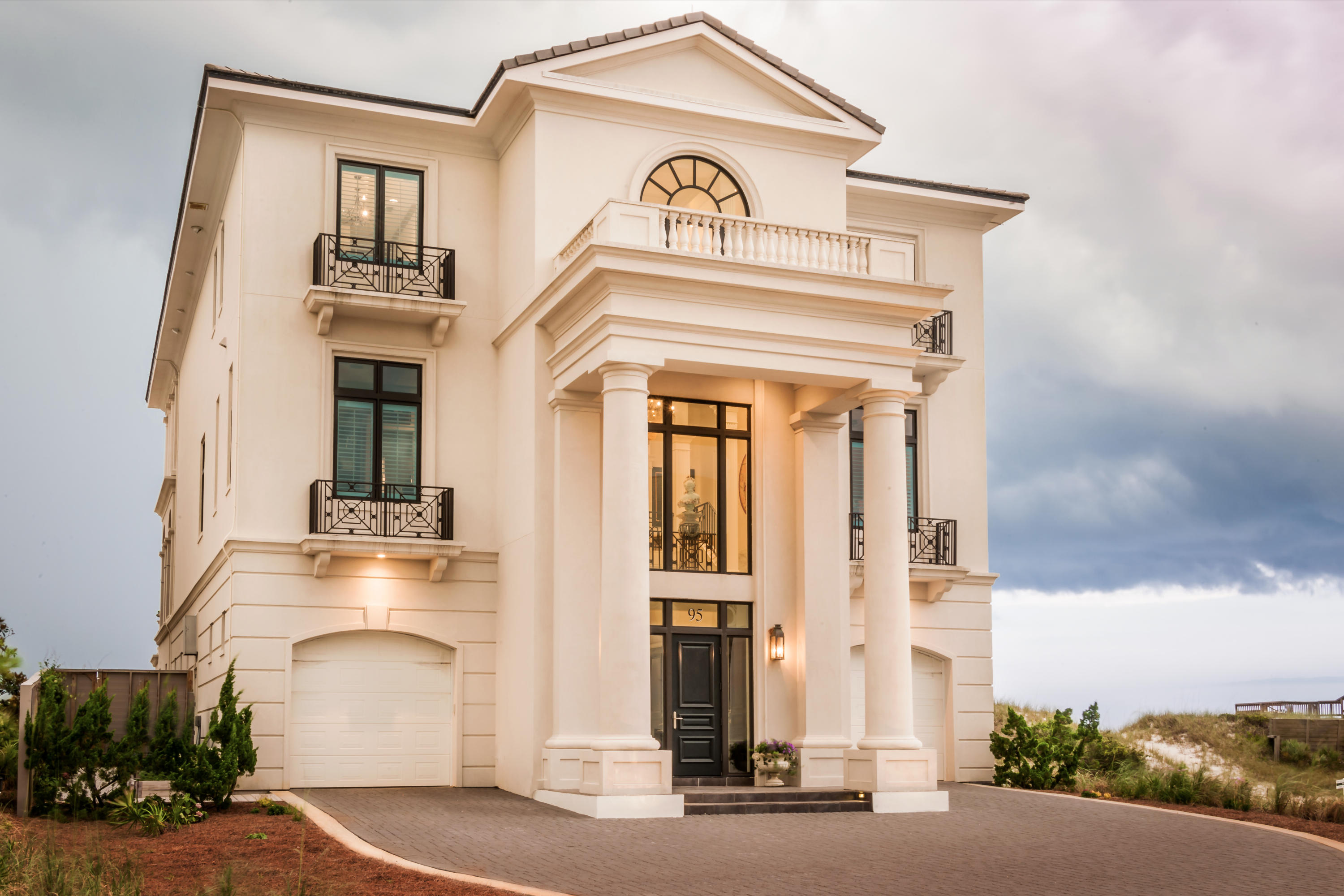 This gulf front home in the gated community of Stallworth Preserve is adjacent to Topsail State Park and the rare coastal dune lakes on 30A providing ultimate privacy. The stunning Palladian design with French flair is an architectural wonder and one of the most unique homes on the Emerald Coast.As you enter the grand foyer, prepare to be captivated by the stunning accent wall encompassing oyster shells illuminated from the light below. The extravagant Turkish chandelier with plexi -glass beads with tea leaves and open stairwell with custom railing create an unsurpassed ambiance. Cross- vaulted ceilings with art light accents, venetian plaster walls and ceilings and Carrera marble floors are