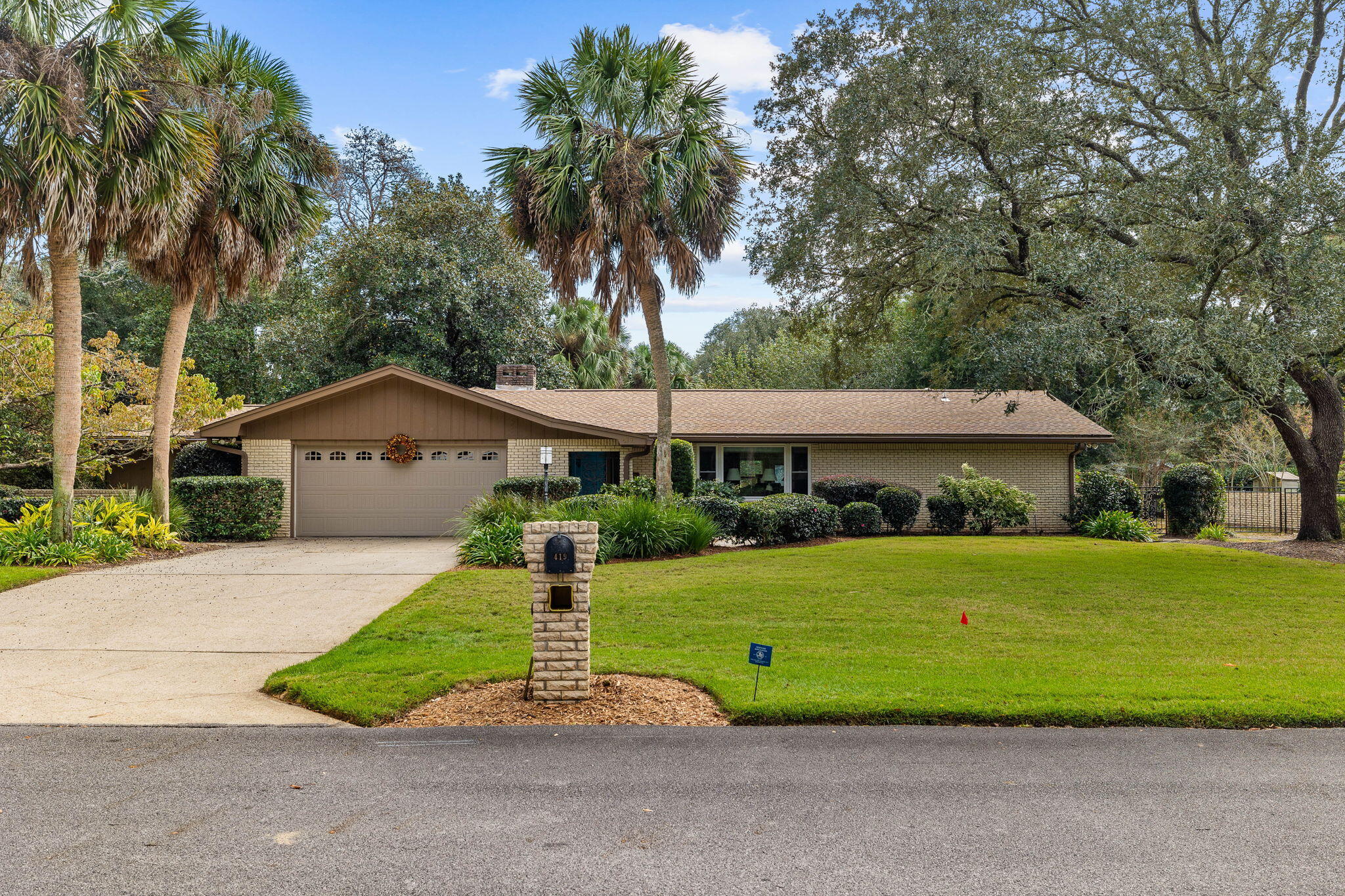 Nestled alongside the 11th hole of the Rocky Bayou Country Club, this charming single-story home in sought-after Rocky Bayou Country Club Estates offers the perfect blend of comfort, convenience and scenic views. Set on a spacious lot with mature trees and manicured landscaping, this well-maintained property is ideal for families and retirees alike.  Inside, a thoughtfully designed floor plan provides a seamless flow between living spaces. The remodeled kitchen shines with modern finishes, while the cozy den, complete with a brick fireplace, offers a warm retreat. The light-filled Florida room provides panoramic views of the golf course and serves as an inviting extension of the living area. The primary bedroom opens directly into this serene space and features an ensuite bath with double sinks, a dressing area and a glass-enclosed shower.  

Additional bedrooms and a hall bath offer privacy and flexibility, while the dedicated office with built-in shelving is perfect for remote work or study. Outside, the 8' x 15' greenhouse and 10' x 16' powered shed cater to hobbyists and gardeners. A fenced yard, complete with a sprinkler system, ensures privacy and ease of maintenance.  Conveniently located near top-rated Niceville schools, Northwest Florida State College, Eglin Air Force Base and the Mid-Bay Bridge, this home offers easy access to the best of the Emerald Coast, including pristine beaches and dining. Memberships to the nearby Rocky Bayou Country Club are available, adding another layer of lifestyle appeal.  