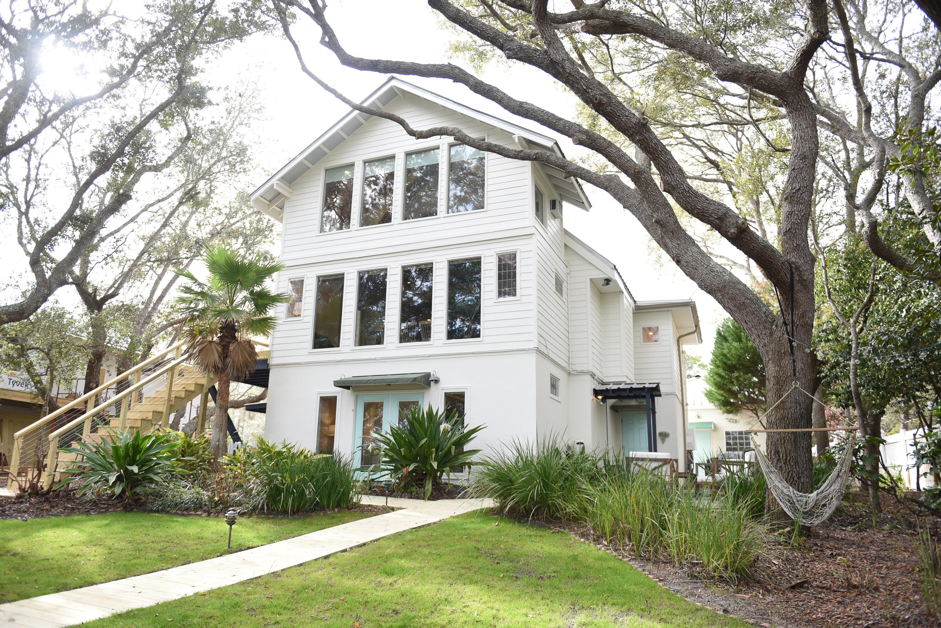It doesn't get much better than beach life on Eastern Lake! This unique 5 bedroom plus pool house is currently a lucrative rental investment with over $148K on the 2021 books and net income projections exceeding $180,000. The expansive outdoor area is truly a zen oasis--relax in the pool while listening to the cascading water from the nearby koi pond or take your boat out from its dockside lift for sunset drinks on the dune lake. The beach access is a minute half golf cart ride or take a paddle board from the private dock right to the sand! The main home has beautiful lake views from the first floor master suite, second floor living areas and third floor 'treehouse' bedroom. The poolhouse studio is equipped with a full kitchen & bath and offers plenty of privacy for house guests