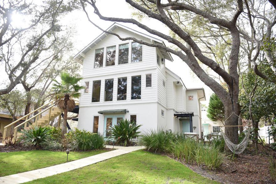 It doesn't get much better than beach life on Eastern Lake! This unique 5 bedroom plus pool house is currently a lucrative rental investment with over $148K on the 2021 books and net income projections exceeding $180,000. The expansive outdoor area is truly a zen oasis--relax in the pool while listening to the cascading water from the nearby koi pond or take your boat out from its dockside lift for sunset drinks on the dune lake. The beach access is a minute half golf cart ride or take a paddle board from the private dock right to the sand! The main home has beautiful lake views from the first floor master suite, second floor living areas and third floor 'treehouse' bedroom. The poolhouse studio is equipped with a full kitchen & bath and offers plenty of privacy for house guests