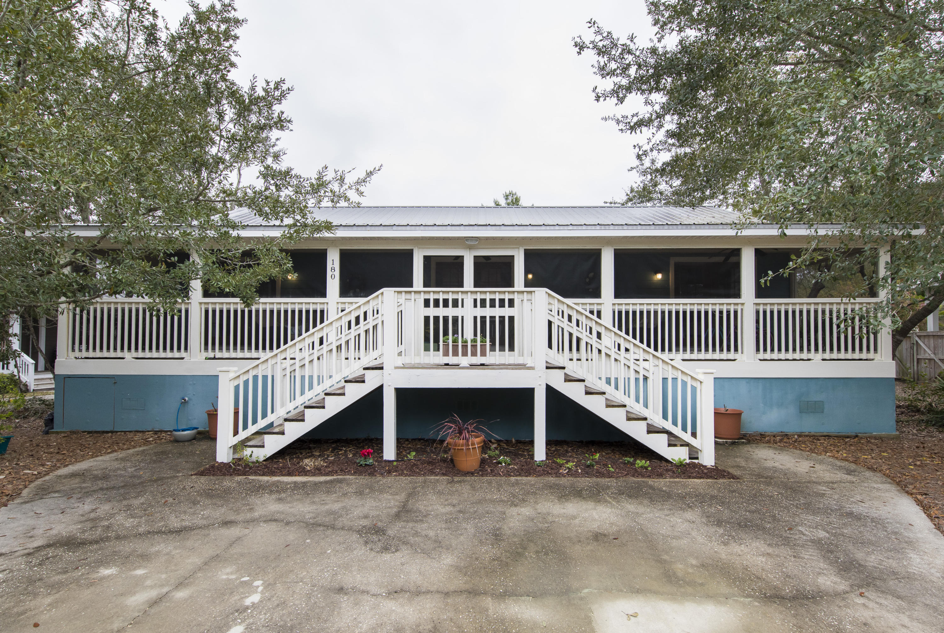Compelling and unique opportunity to own a phenomenal home near Highway 30a. This home has gone through a recent renovation with new granite, updated stainless steel appliances, and the floors have also been redone. This extraordinary home has an open and spacious feel which makes this home an absolute show stopper with a low price for similar homes on 30a, a true value for an investor or primary home owner. Whites Gulfview is a Deeded Beach Access community (access is just two blocks away) with low HOA fees and is located on the east end of 30a near Alys Beach and Rosemary Beach. Boasting 1505 heated/cooled square feet under roof, and 650 square feet of porches, this home provides ample space as a short-term rental (investme This lovely coastal home boasts 3 bedrooms, an oversized living room, dining/kitchen combo and 2 full bathrooms. Features include large back and front porches. The front porch is screened in so that you can feel the breeze coming off the Gulf while reading your favorite book. Serene views of nearby state forests also abound to the north side of the home. This one-story home features a cozy and inviting open concept layout including the living room, kitchen, and dining area. Double master bedroom located on both sides of the home provides for ultimate comfort. Private bedroom off back of one side of the home is situated away from the master bedroom.
The oversized lot has a large driveway for a minimum of four vehicles. Many high-end, multi million-dollar homes are being built nearby right now and help to make this home an incomparable value.
It is very difficult to locate a single-family home that offers this location and these attributes at such an affordable price.