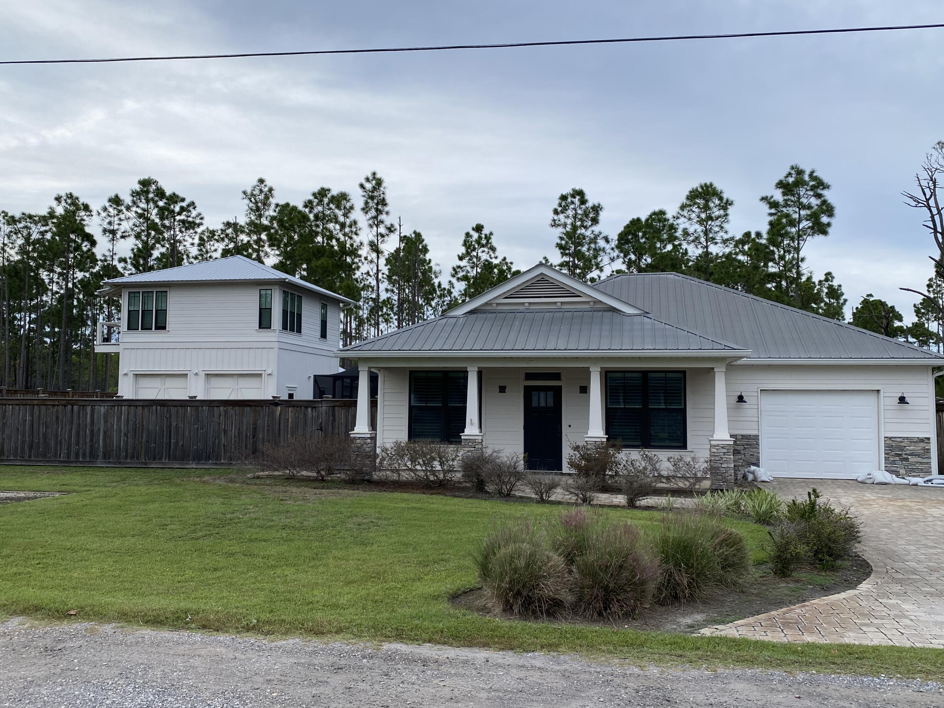 TRUELY A MUST SEE! Nestled in the serene enclave of Santa Rosa Beach, Florida, 154 Delbert Lane beckons with its promise of coastal potential and tranquility. This 3-bedroom, 2-bathroom residence has an open living, dining, and kitchen area ready for those with a vision and a flair for transformation, this home offers a fixer-upper opportunity, allowing you to craft your coastal retreat.In 2019, the owners added a detached, oversized two-car garage with a 650sf apartment above complete with a 1 bedroom, full kitchen and living room. There's also another insulated, heated/cooled, building for storage or equipment. Best of all, is the private outdoor living space with screened-in pool and hut tub, fireplace, brick-paved patio with plenty of...