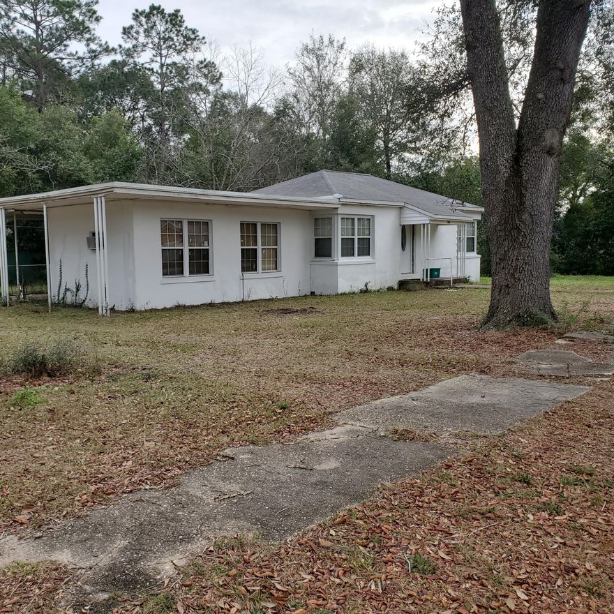Right in the heart of Crestview! This home is perfect for someone wanting to make some updates or an investor. This home sits on .30 acre corner lot in town! As you enter the home, you are greeted with original hardwood floors in the living room and a large family room with access to the fenced back yard. There are two bedrooms at the end of the hall and a full bath. The kitchen has a door leading to the enclosed florida room and laundry room. Make your appointment today!