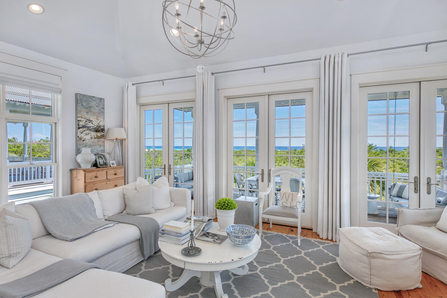 This exceptionally beautiful crisp white Southern yet sophisticated home has panoramic views of the Gulf of Mexico and also overlooks the tranquil Cypress pond. As you drive up to this newly (2021) painted 3 story home, you will be greeted by a large parking area complete with a landscaped arbor with views of the Cypress Pond. Once you enter this house, which has been featured in 2 prominent Coastal magazines, you will truly know you are HOME. On the first floor, is a large entry area, a 2 car garage, and laundry room. You will also see the first bedroom with custom built-in queen sized bunks, a bathroom with with large sink and grand shower.