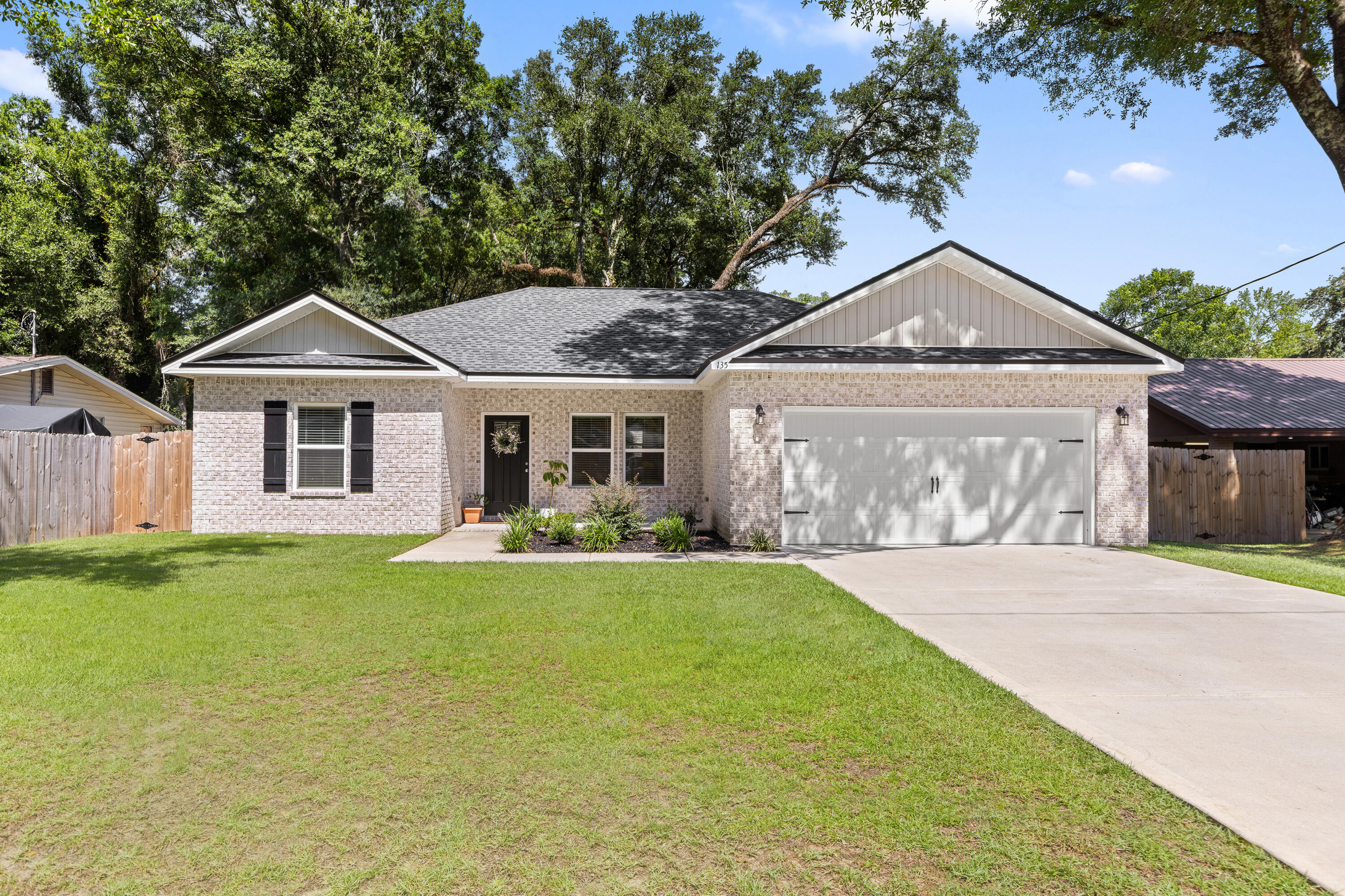Showings begin Saturday 7/19.Beautiful all brick home and built in 2023. Two car garage, three bedrooms, two bathrooms, and situated on flat quarter acre lot. This home offers an open concept living, dining and kitchen. The kitchen includes a large island, quart countertops and stainless-steel appliances. With recessed lighting throughout, a split floor plan, quartz counters in bathrooms, LVP and 10 ft ceilings in the main areas, and large walk-in closet in the primary bathroom means this home will not disappoint! Gorgeous backyard and stunning mature oak tree make this a wonderful setting for pets, cookouts and gatherings. Call and schedule an appointment and check this home out for yourself.