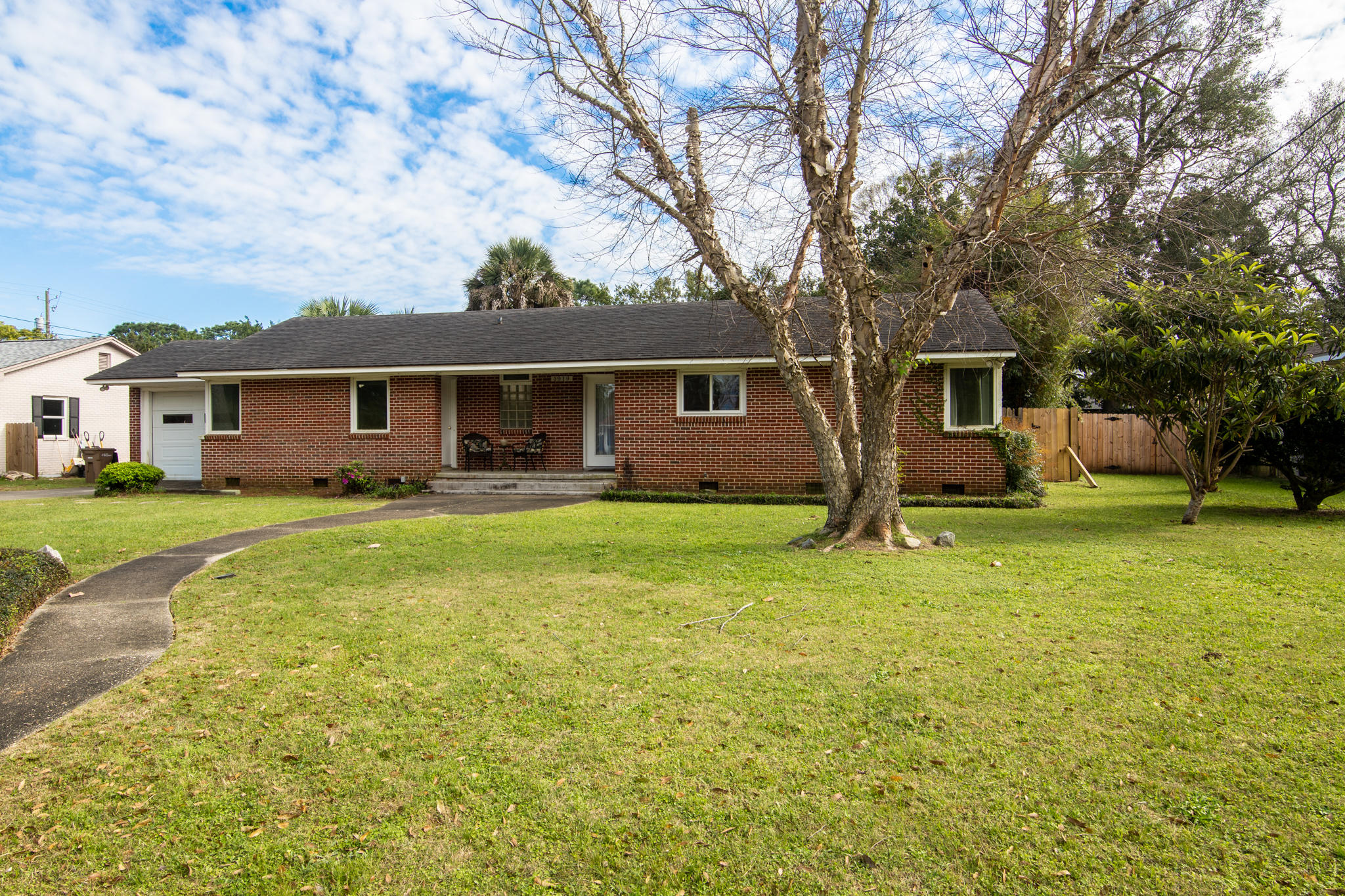 Welcome to the heart of East Hill!! This 3 bedroom charmer is situated on over a quarter acre with sprawling front and back yards. This full brick home features original hardwood floors throughout with tile in kitchen and bathroom. Remodeled in 2006 to include double pane windows, blown in insulation in ceilings, new roof, converted to copper wiring and water/sewer lines to street. The spacious open living area features a fireplace and beautiful wood beams spanning the entire length of the ceiling. French doors off the living area lead to the massive backyard and your own private oasis. The quaint screened in patio allows for the perfect mix of ultimate entertainment and rest and relaxation. The over sized garage is an additional 532 square feet with and this lot is 90 x 132.5 with endless