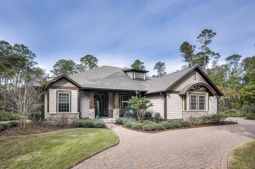 Beautiful craftsman style single level home on .829 acres in Wild Heron! This home welcomes you with a beautiful paver circle driveway and river rock column front porch. The open floor plan and high ceilings make home perfect for entertaining. It also features both a formal and casual dining area. The large kitchen island opens to the living area that features a fireplace and doors that are completed with electronic blinds. These doors open to a large screened in porch. They can open completely so it is as if these two areas are one, or remain closed to make 2 completely separate areas, you choose! The large screened in porch is complete with several sitting areas, a summer kitchen, fireplace and media area. There is also an open deck area perfect for grilling.