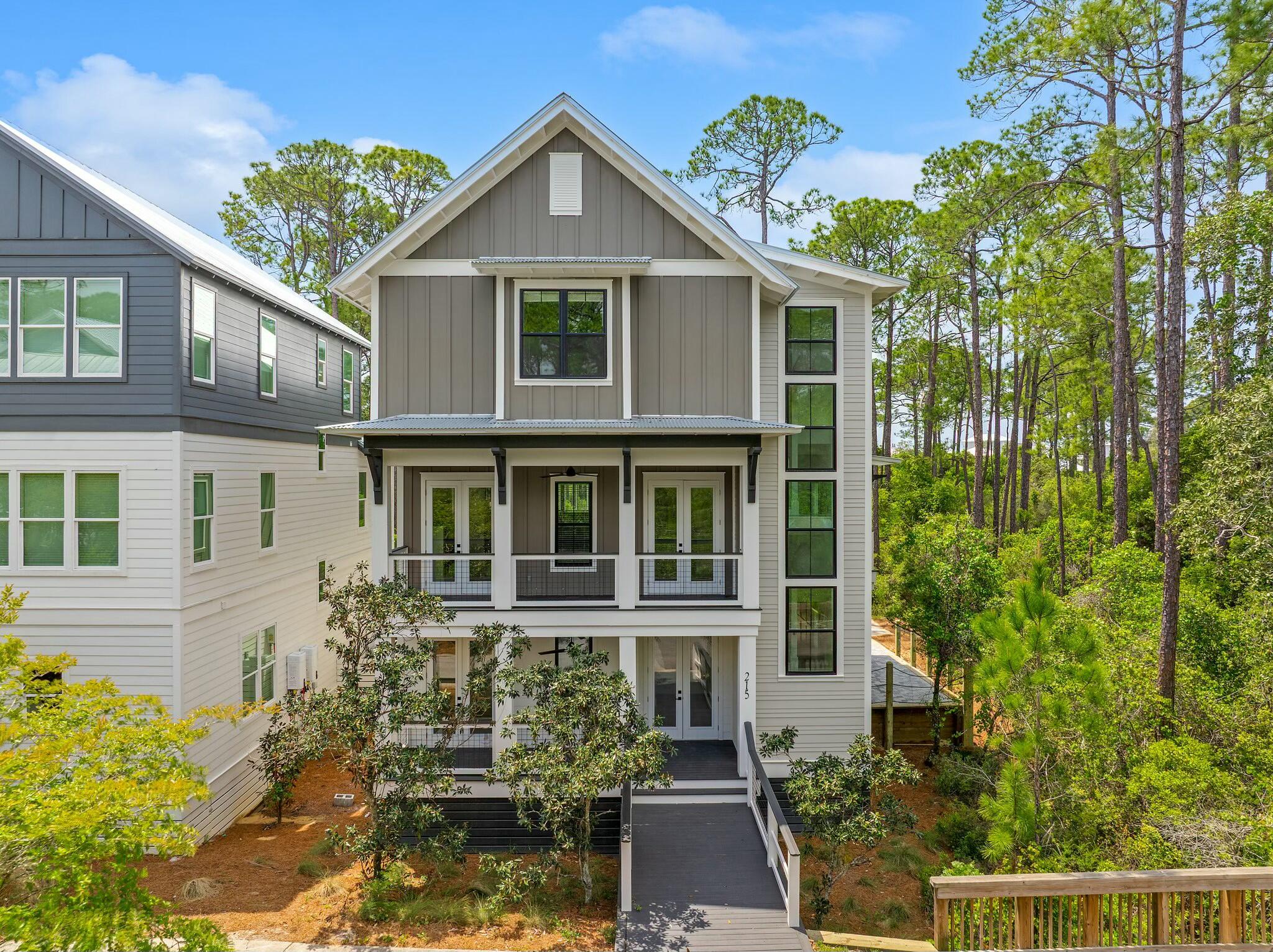 Expertly crafted, this 2,928 sq. ft. Treetop Village home, offers  privacy, convenience, and luxury coastal living. Ideally located between Alys Beach and Rosemary Beach, it provides easy access to top dining, shopping, and entertainment. Enjoy expansive porches perfect for relaxing and a rare full two-car garage. Deeded beach access and a tram service make reaching the sugar-white sands effortless. With gated entrances on Scenic Hwy 30A and Hwy 98, Treetop Village ensures privacy while giving you all that Seacrest, Alys, and Rosemary Beach have to offer. Whether you're seeking a primary home, vacation getaway, or investment, 215 Redbud Ln delivers the best of the 30A lifestyle in one of its most desirable communities. Owner financing available with agreeable terms. Owner/Agent