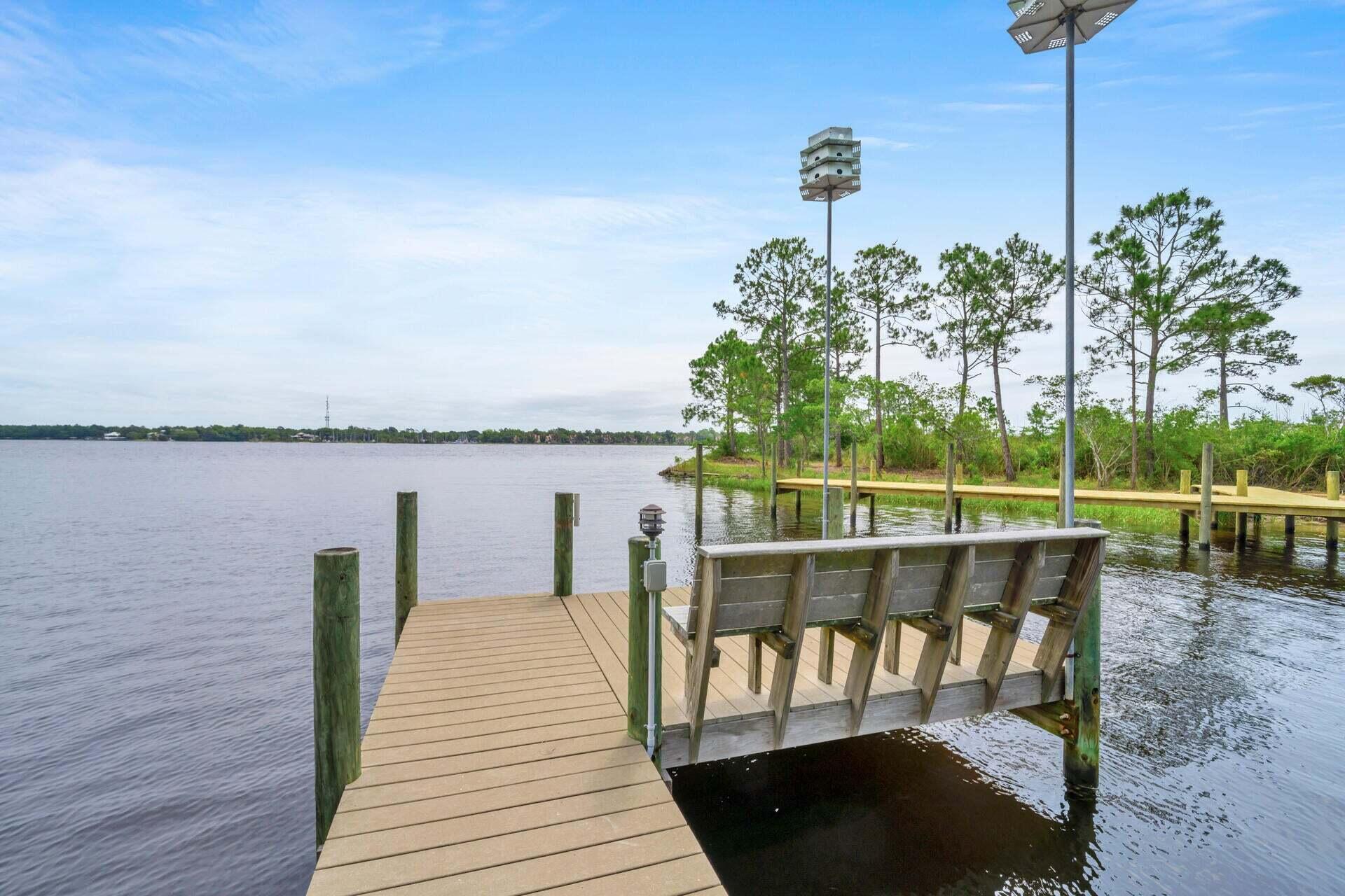 Bayfront Luxury with Stunning Views! Nestled on a 1/2-acre wooded lot with 75 feet of waterfront and a deep-water dock, this fully remodeled 2800 SF home offers breathtaking views of Rocky Bayou. Designed for comfort and elegance, it features 4 bedrooms, 3 baths, and a spacious walkout balcony to take in the serene scenery. Upgrades Galore! Fresh interior & exterior paint, LVP flooring throughout, Modern LED lighting, Elegant marble countertops throughout, High-end soft-close cabinets & drawers in the kitchen and baths, Stylish new staircase and railing, Electric fireplace & new interior doors. Designed for effortless Living, the open-concept kitchen shines with a breakfast bar, coffee bar, and plenty of space to entertain. This waterfront gem is a rare find--schedule your showing today!