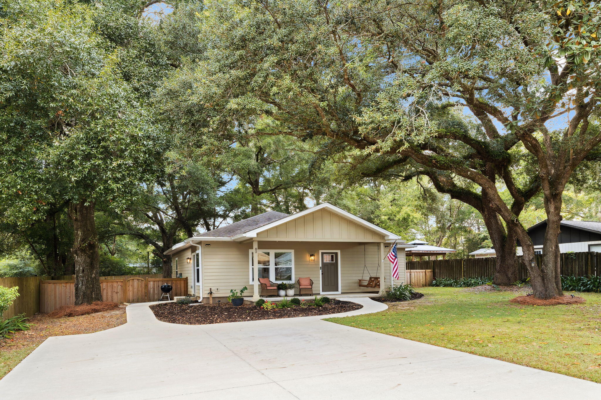 Welcome to 82 Live Oak, a custom-built home by Brannen Construction situated on nearly a half-acre lot and framed by mature live oak trees. Its prime location in the heart of Freeport places it within walking distance to Freeport Elementary, Freeport Learning Center, Register Farm Market, Family Dollar, Ascension Primary Care, and more, with Freeport Middle and High Schools just a short drive away. This charming residence enjoys a quiet setting at the end of a dead-end street, no HOA, and privacy fencing with custom gates. New aluminum gutters with guards, front landscaping, fresh planted grass in both front and back yards, and a fire pit patio and walkway add to the home's curb appeal. Inside, the open-concept layout blends functionality with modern style. The spacious family room creates a welcoming space for gatherings, flowing seamlessly into the chef's kitchen. Here, expansive quartz countertops, stainless steel appliances, and white shaker cabinets provide both beauty and practicality. Throughout the home, durable LVP flooring and freshly painted bathrooms offer a clean look. The primary suite serves as a private retreat, featuring a generous layout with a primary bathroom and a spacious walk-in closet. Two additional bedrooms and a second full bathroom provide plenty of space for family or guests, and a sizable laundry room with built-in shelving ensures you stay organized.
Step outside to enjoy the expansive outdoor living area, which includes a fenced backyard and a fire pit area perfect for evening gatherings. Adding practical storage solutions, a 10x12 shed serves as an excellent space for storing lawn equipment or outdoor toys. Designed with efficiency in mind, the home features spray foam insulation, allowing it to cool and heat with ease. Brannen Construction's commitment to quality builds shows in the use of Hardie board siding, double-pane windows, and other energy-efficient details that help with low utility costs. 82 Live Oak offers a rare combination of durability, efficiency, and privacy, making it a standout home in one of Freeport's most convenient locations.
