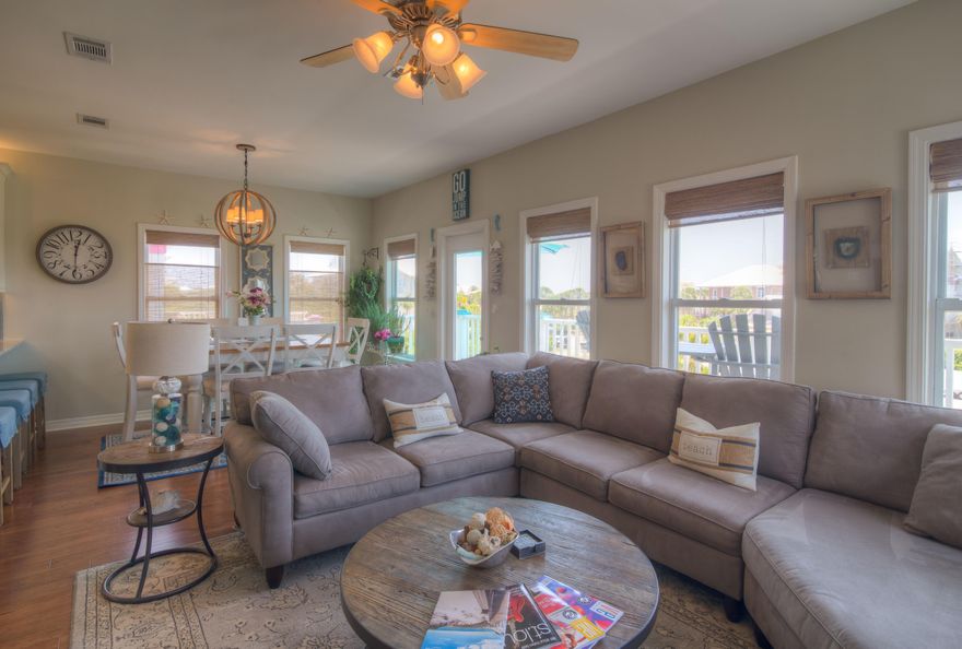 Beautiful beach cottage with spectacular Gulf Views from the 2nd and 3rd floors, is a great investment property or secondary residence. In the popular beach neighborhood of Old Florida Cottages, the beach access of Gulf View Heights is steps away. Turn key for rental income in 2017. This home is tastefully decorated with coastal tones and a comfortable vibe. Reverse floor plan boasts a new kitchen in 2016 with custom cabinetryand all new stainless steel Kitchenaide appliances. First floor has master bedroom and 2 addition guest bedrooms and 2 full baths. Second floor has an open floor plan with living room, dining room, and kitchen. Step out to the balcony to enjoy the best sunsets in the area. Second floor bedroom with on suite bath. Third floor bonus room / office.