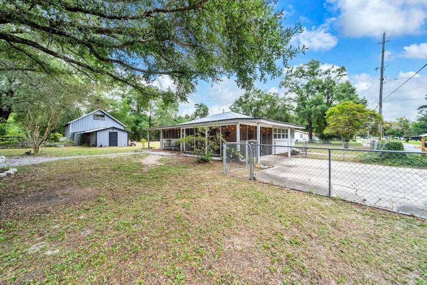 Charming & Versatile 3BR/3BA Home on Half an Acre with Barn & Income Potential! Discover comfort and opportunity in this spacious 3BR/3BA home on a beautifully landscaped 1/2-acre in Defuniak Springs. Perfect for multi-generational living or investors, it features flexible spaces including a private in-law suite with its own entrance and carport. Enjoy a bright sunroom, cozy screened porch, and multiple fenced areas with mature trees and a fire pit. A massive two-story detached barn/workshop offers four rooms, RV hookup, and space for a boat or trailer. With dual entrances and endless versatility, this property is ideal for families or rental income potential--a rare find with so much to offer!