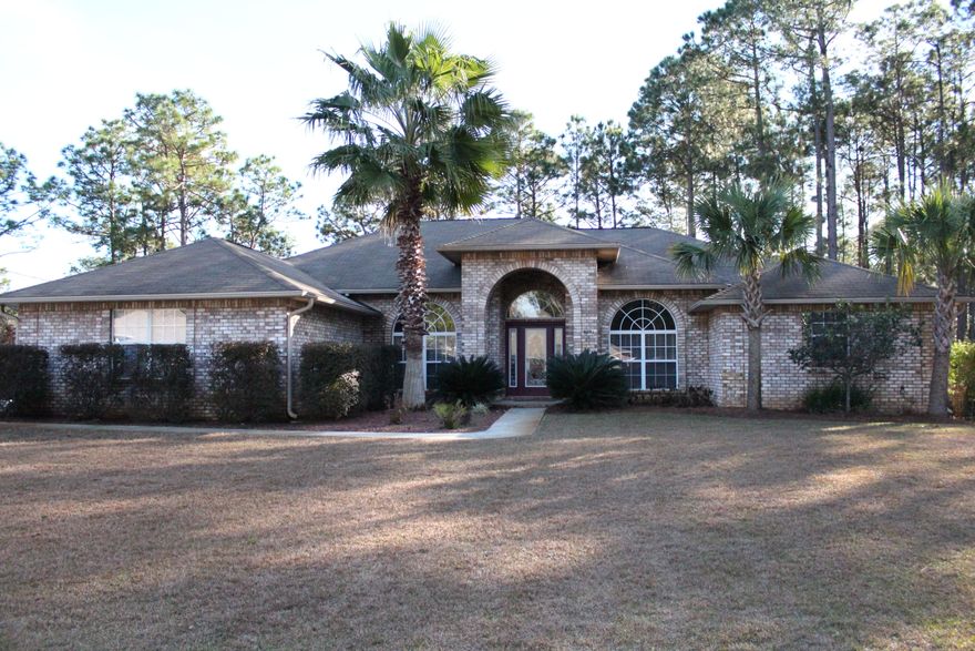 This beautiful Bay Point custom built all brick home has just over 2,300 sq. ft. Features 3 bedrooms and 2 full baths, contemporary split/open floor plan in a quiet setting. The home boasts an elegant entry with raised elevation, column, large porch, with leaded glass door w/sidelites to match. With an open feel and 10' and 9' ceilings everything opens up to an area great for family and entertaining. Upgrades include designer fans, specialty lighting in matching designer fixtures for the formal dining, dining area and above the breakfast bar, plumbed for wetbar w/silestone solid surface top, large breakfast bar, gourmet kitchen, and stainless steel appliances. 5 burner gas range w/hood vent, built-in microwave and oven, specialty tile floor to match hardwood flooring. The master