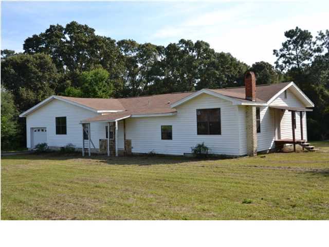 Short sale. Renovated older home on a large country lot! Located just outside the city limits so you save on your property taxes. This home has hardwood flooring throughout the home, except the front 3 rooms. When you step into the home at the front door, you will enter a spacious entry with an archway that accents the additional space that steps up to the Living Room. The large Living Room views the front yard and shows off the beautiful wood floor. The Kitchen/Dining combination has access to the Garage, Laundry Room and French Doors open to the wood deck. Go down the hallway to the 4 Bedrooms: the Master Bedroom and Bathroom are a combination of 3 of the bedrooms in the original house, has hardwood floors & 2 closets, Bedroom 2 has its own entrance plus a place for your wood heater.