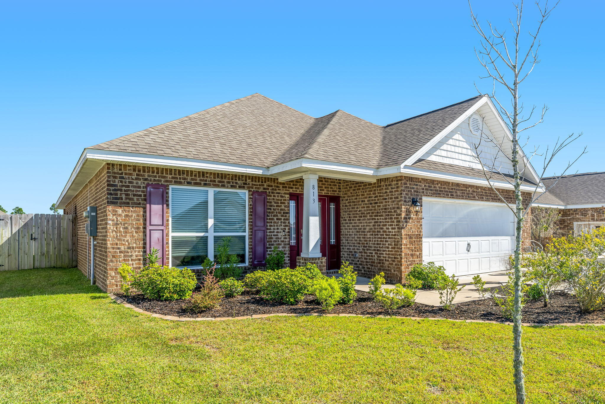 This charming 3-bedroom, 2-bath home, built in 2020, offers 1,720 square feet of modern living space. As you step inside, you're welcomed by beautiful vinyl plank flooring throughout the main areas, with cozy carpet in the bedrooms. The home boasts 9-foot ceilings, with tray ceilings adding a touch of sophistication to both the living room and the primary bedroom. The kitchen is a standout feature, complete with an eat-in breakfast nook that flows seamlessly into the spacious family room, perfect for casual meals and entertaining. The dining room, just off the foyer, provides an elegant setting with tray ceilings and views of the landscaped front yard. The primary suite is a true retreat, featuring a walk-in closet, a large soaking tub, and a separate tiled shower. Two additional bedrooms share a well-appointed hall bath, and the convenient laundry area is located just off the garage. With thoughtful details like brushed nickel hardware, elegant cabinetry in both the kitchen and bathrooms, and a well-designed layout, this home offers a blend of comfort and style.