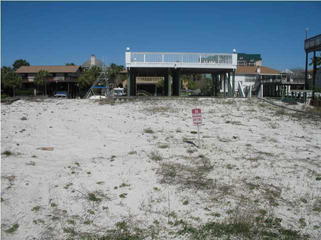 This lot has been filled and ready to be built on. Property contains Vinyl Seawall and TWO covered Boat Slips with large Deck on top. One of the boat slips is currently rented for $5,000. per year. 90 Feet of very limited Destin Water frontage. Water Taps paid. A short walk to the Holiday Isle deeded beach walk-over. Only 10 minutes to the Gulf of Mexico at idle speed in your boat. When you consider all the above you begin to understand why this property is the best waterfront buy in all of Destin. ''OWNER SAYS TO BRING ALL OFFERS''